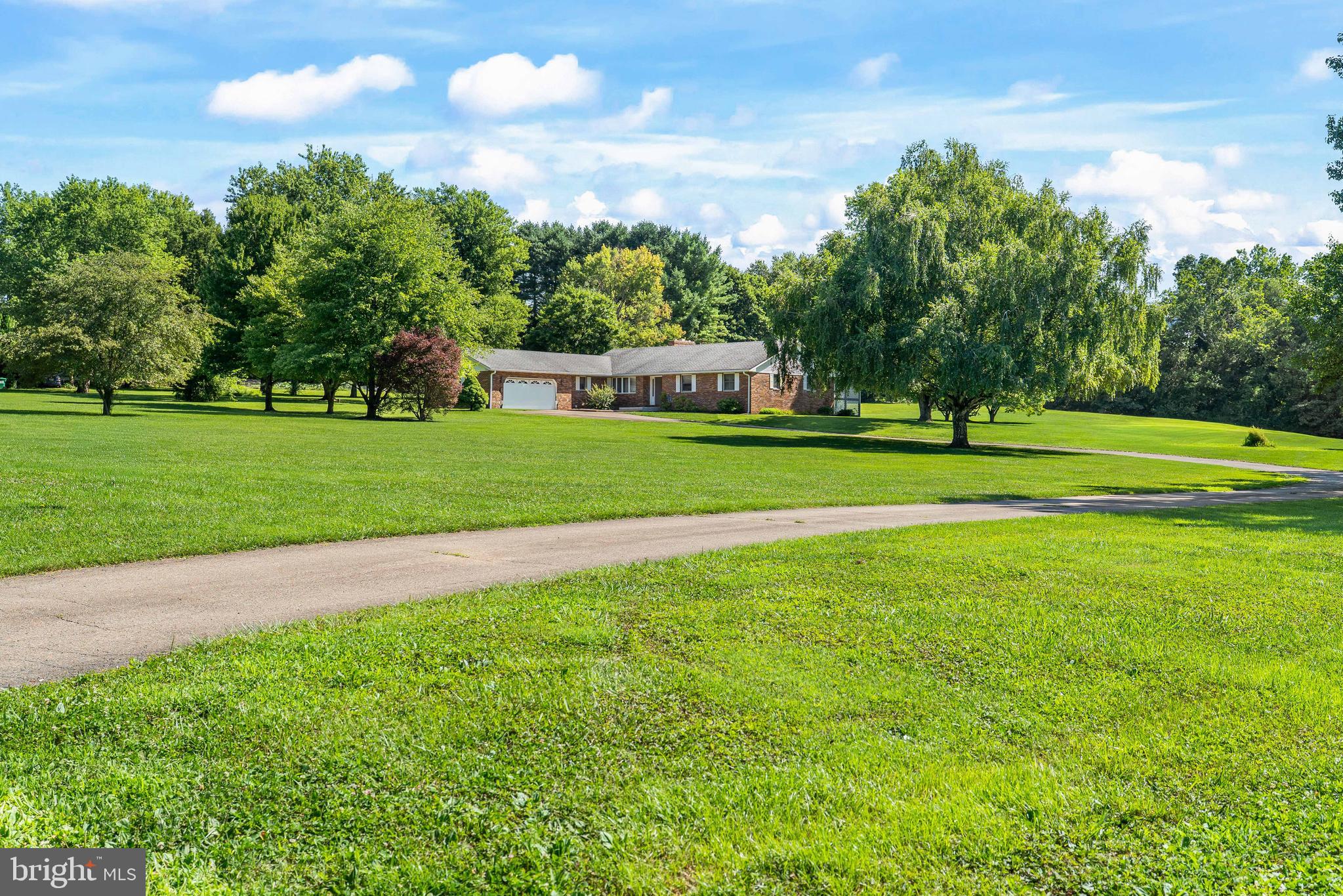 What a great home!  This custom built brick rancher sits on just under 6 acres and offers over 2000 sf of living space. Features include 3 bedrooms and 2.5 baths, The owners suite has a walk-in closet, en suite bath. and sliders to a rear deck. Most of the main level has hardwoods.  The sunken-in family room has a wood burning fireplace. The kitchen has cherry cabinets and corian counters. There is a separate dining room and a den.  The two car garage has access to a large mud room just off the kitchen. The property is nice and open, leaving plenty of space for gardens, a pole barn, or a swimming pool!  Rising Sun School District (buyer to verify).