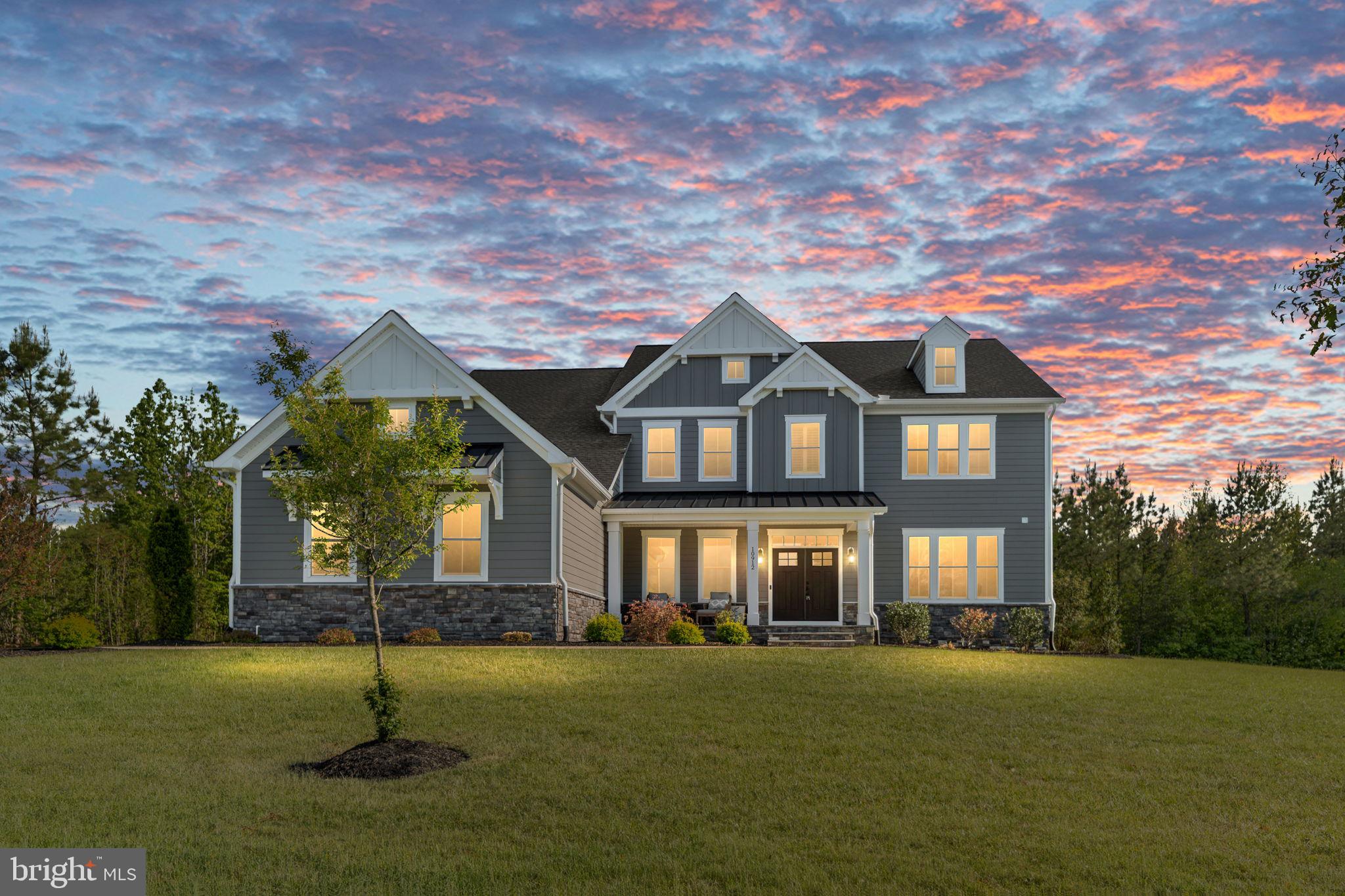Welcome home to 10192 Downton Ave, a stunning retreat offering 6 bedrooms, 5 full baths, and 2 half baths across three finished levels, perfectly positioned on 5 private, wooded acres.

Step inside to discover rich white oak hardwood floors spanning the main level and leading into the heart of the home: a chef-inspired gourmet kitchen. Outfitted with sleek quartz countertops, premium stainless steel appliances, custom soft-close cabinetry, and a massive oversized center island, it’s built for both everyday family meals and effortless entertaining.

Flexibility meets accessibility with a rare main-level en-suite bedroom, ideal for guests or multi-generational living. Upstairs, the primary retreat features elegant tray ceilings and a lavish, spa-like primary bath designed for ultimate relaxation.

The fully finished lower level expands your living space with a huge rec room, a dedicated bedroom, one full bath, one half bath, and ample unfinished storage space for all your seasonal needs.

Outdoors, unwind or entertain on the low-maintenance composite deck surrounded by peaceful nature views. Additional highlights include a 3-car garage with a built-in EV charger. Enjoy complete privacy without sacrificing convenience—located just minutes from shopping, dining, and historical attractions in Fredericksburg!