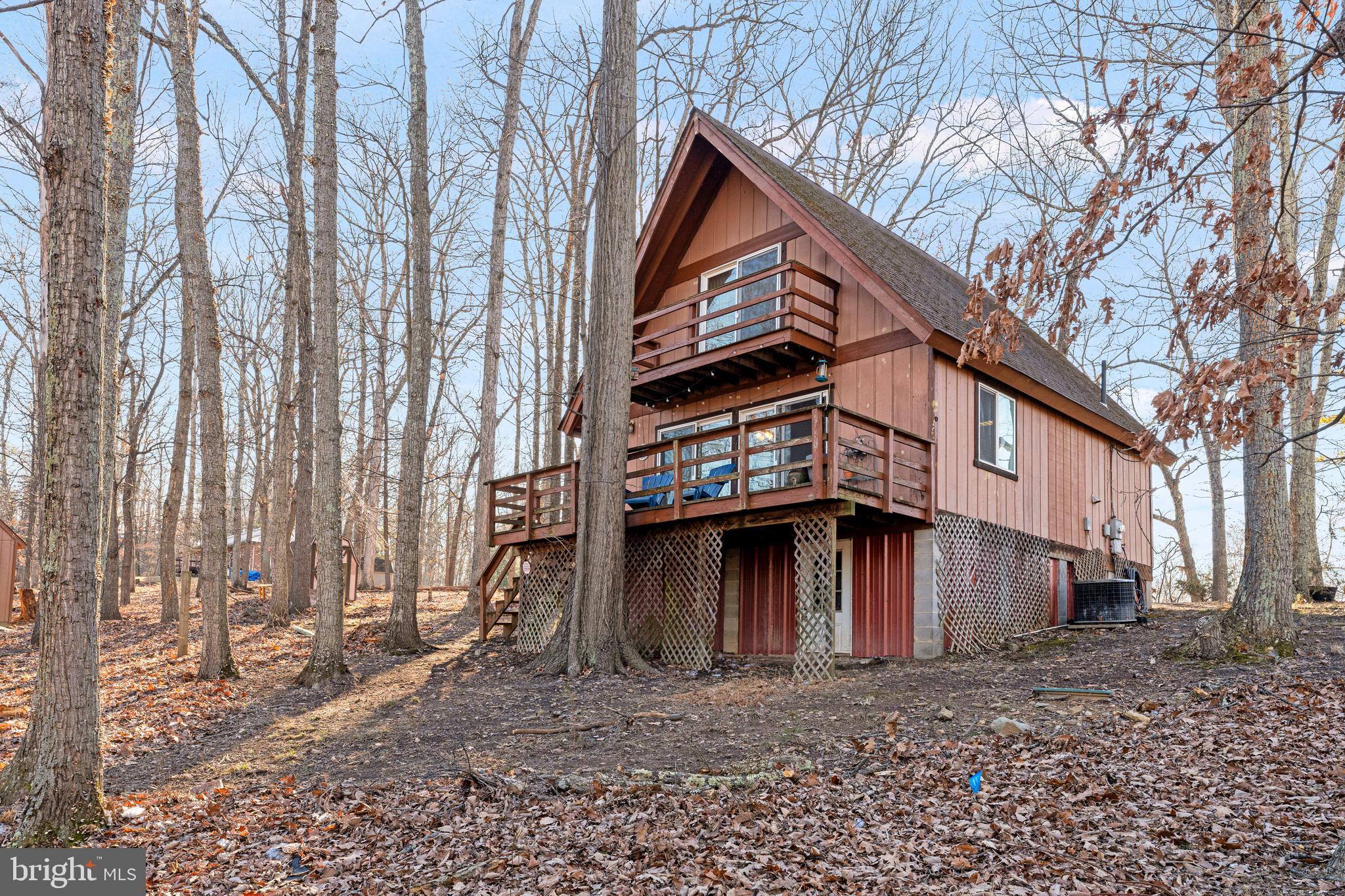 Nestled in the serene Apple Mountain Lake community, this charming 3-bedroom, 1-bathroom A-frame home offers a peaceful retreat with breathtaking mountain views while being just minutes from I-66. Situated on 1.11 acres, the main level features a bright, airy living room with sliding doors leading to a spacious deck where you can sip your morning coffee or unwind in the evening while enjoying the stunning scenery. The main level includes a well-equipped kitchen, a dining area, a convenient laundry space, and a bedroom with a full bath. Upstairs, you’ll find two additional bedrooms, one of which boasts a private balcony perfect for enjoying the scenery. The property also includes a garage with a window, electricity, and a shed for extra storage. Whether you're looking for a full-time residence or a weekend getaway, this home provides the perfect blend of tranquility and accessibility. Mother  Nature will be showing off all her beauty soon!  Don’t miss out on this unique mountain retreat—schedule your showing today!

Main Level:
Bedroom with full bath
Kitchen
Laundry area
Dining area
Living room
Upper Level:
Two bedrooms, one featuring a private balcony
Garage  with window and electricity
Shed