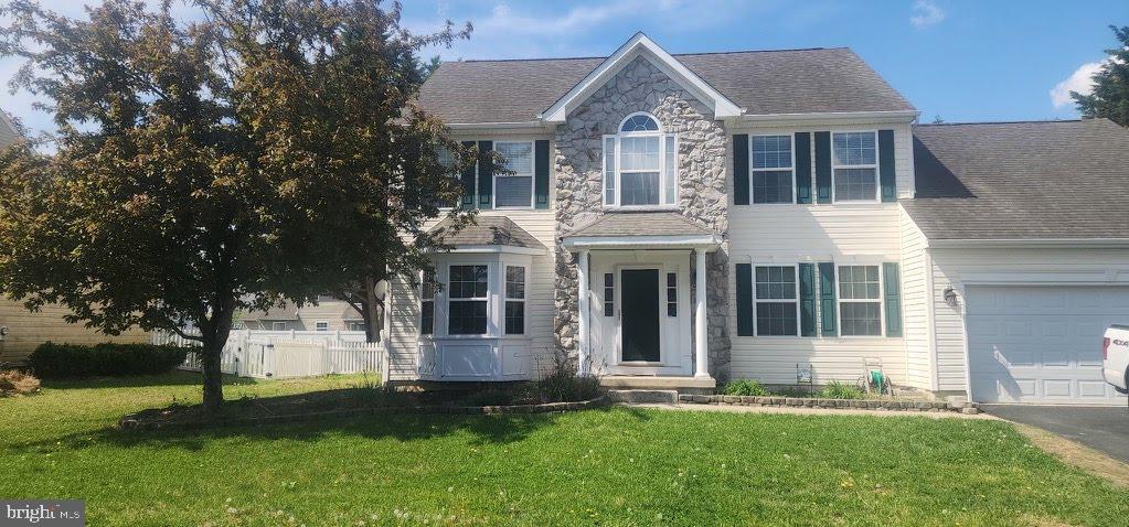 "NOW PRICED BELOW MARKET FOR A QUICK SALE"
Rare "Re-freshed" 4/5 bedroom colonial on premium corner lot!  This stunning stone front colonial is move in ready!  Located in highly sought after Garrison's Lake Green.  This home offers a perfect blend of traditional elegance and modern flexibility.   
The first floor room is perfect for the 5th bedroom/guestroom, office or hobby room.  Gleaming hardwood floors throughout the majority of the main level, accented by classic crown moldings and chair rails.   
A chef's kitchen features a large center island, pantry and sun filled breakfast area- perfect for entertaining.
Outside living is just a step out from the kitchen- large deck overlooks a fully fenced rear yard- a perfect oasis.
A massive unfinished full basement with windows means endless options to grow!