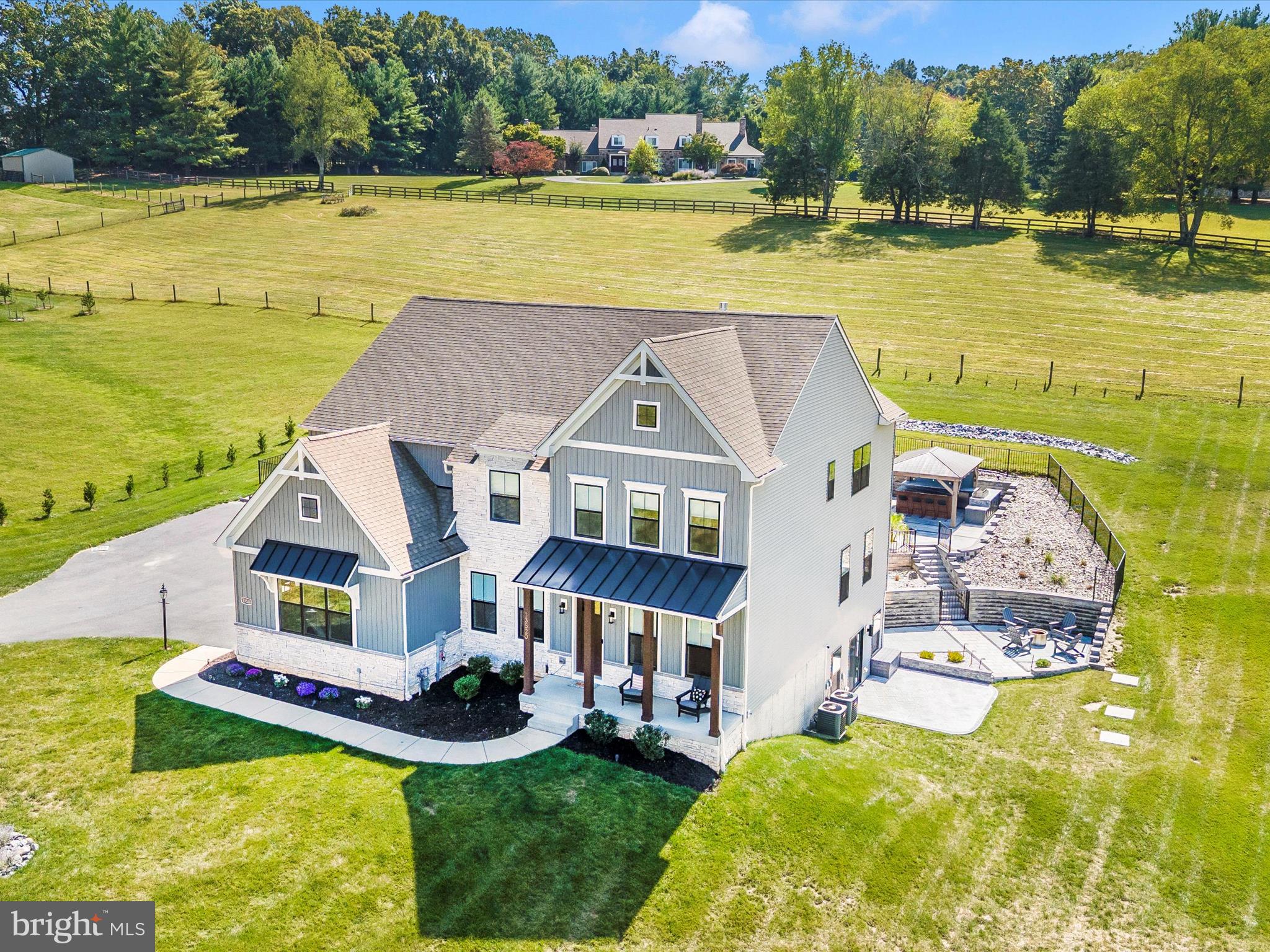 Welcome to your dream home. A stunning 5,000 sq. ft, 5-bedroom, 5.5-bath masterpiece nestled on 1.4 acres of serene land, blending luxury and functionality. Step into the main level with soaring 10’ ceilings, upgraded LVP flooring, and a 2-story family room featuring a coffered ceiling, custom Venetian plastered fireplace wall, and expansive windows flooding the space with natural light. The gourmet kitchen is a chef’s delight, showcasing a quartz backsplash and countertops, a large island with bar seating for four, a gas cooktop, double wall ovens, a built-in Bosch coffee/latte machine, a 48” refrigerator, and a custom walk-in pantry with a sink, disposal, additional fridge/freezer, and ample storage. Upstairs, the primary suite offers a spa-inspired bath and upgraded built-in closet systems, joined by three additional bedrooms, two full baths, and a spacious laundry room. The fully finished basement is an entertainer’s paradise, featuring a custom bar with granite countertops, two beverage coolers, an ice maker, brick veneer, and white oak shelves with lighting, alongside a theater/entertainment area with in-wall speakers, a dry bar, a large rec room, a flex room, and a full bath. Outside, indulge in a 36x18 saltwater heated pool and spa with smart-home automation, paver decking, a half basketball court, and an outdoor kitchen gazebo with granite countertops, a tile backsplash, a 40” Blaze grill, and lighting/fan with pre-wired electric for future heaters, all enhanced by a three-zone outdoor speaker system, black aluminum pool fencing, and an invisible pet fence. With easy access to I-70 and vibrant downtown Mt Airy for shopping and dining, this extraordinary home offers an unparalleled lifestyle—schedule your tour today!
