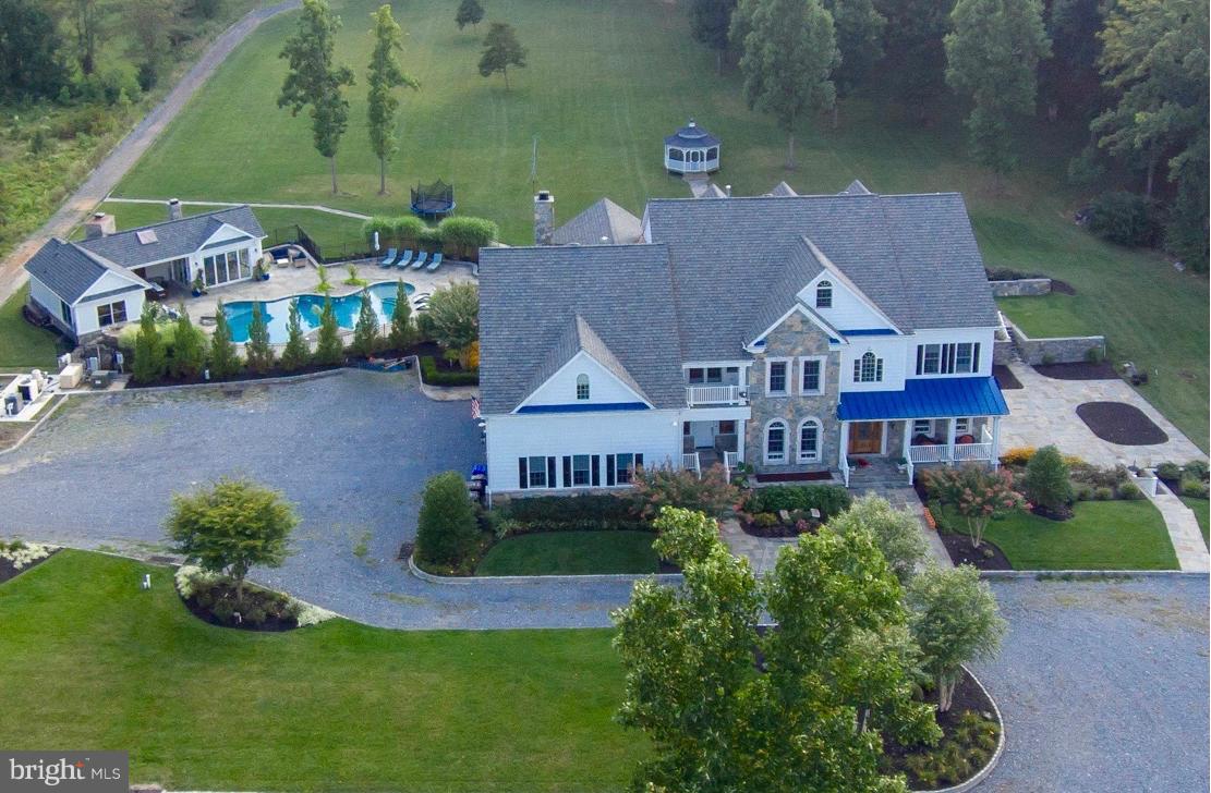 Extraordinary custom luxury home. Gorgeous architecture. Chefs kitchen with every possible upgrade. Exquisite pool house with heat/cooling, full bath, fireplace, gourmet indoor/outdoor kitchen, bar, pizza oven, retractable walls & more. Heated pool, waterfall & hot tub, premium landscapes, koi ponds & gazebo. Separate apt. w/ private entrance. 4-car heated garage. Horses allowed. Dream lifestyle!
