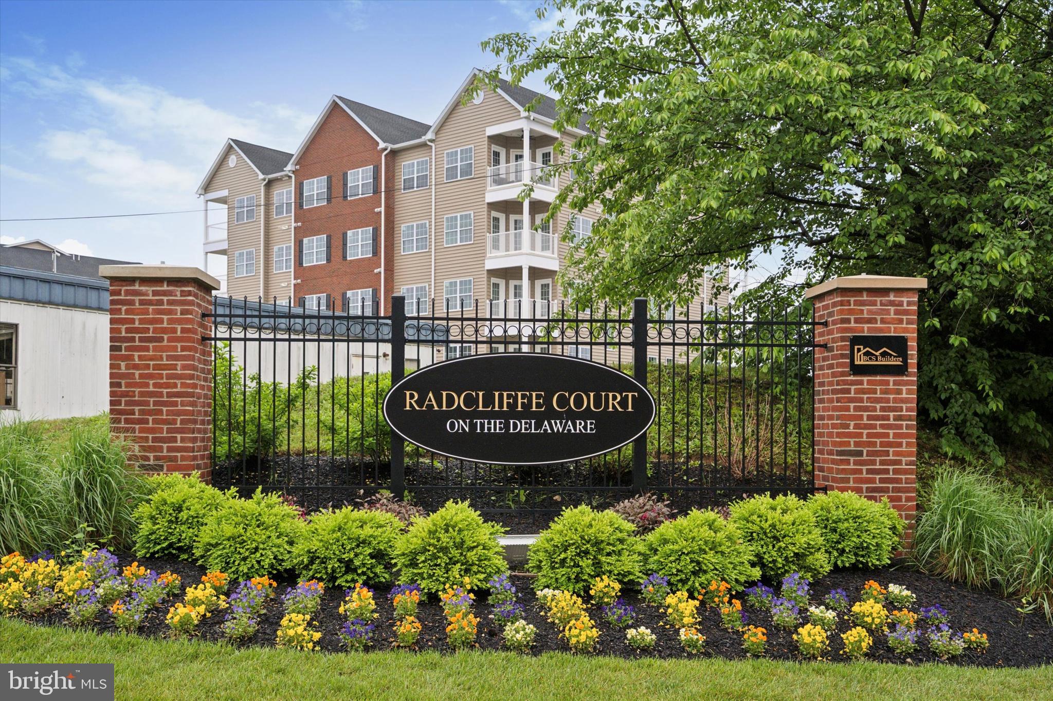 Welcome to the Condos at Radcliffe Court on the Delaware, Bucks County’s premier new-construction condominium community.

This exceptional development features 96 affordable luxury residences and represents the largest residential development ever built in Historic Bristol Borough. Building upon an already successful townhome neighborhood, the Condos at Radcliffe Court uniquely blends small-town borough charm with modern city living.

Each thoughtfully designed condominium offers 2 bedrooms and 2 full bathrooms, highlighted by an open-concept layout that seamlessly connects the living room, dining area, and kitchen—ideal for both everyday living and entertaining. Buyers may personalize their home by selecting from a wide range of hardwood flooring, tile and carpet options in addition to the many different choices for kitchen cabinets, countertops and backsplashes.

The spacious U-shaped kitchen features beautiful cabinet selections, granite countertops, and a stainless-steel appliance package, creating a stylish and functional heart of the home.

The primary suite includes generous closet space and a private en-suite bathroom with a double-bowl vanity, custom tile shower, and ceramic tile flooring. The second bedroom is conveniently served by a hall bathroom that also functions as a guest powder room, complete with a one-piece fiberglass tub/shower combination and matching cabinet and countertop finishes.

Every residence is equipped with energy-efficient HVAC systems, LED recessed lighting throughout, elevator access to every level, and one reserved parking space per unit. In addition to covered parking beneath each building, residents enjoy ample additional parking throughout this section of the community and in the adjacent lot.

The development is nestled on the banks of the Delaware River and positioned along the 4.5 mile trail that runs throughout this incredible town. Just minutes from I-95, the PA/NJ Turnpike, SEPTA and NJ Rail Lines, this is the most centralized development in Bucks County!

Contact us about some incredible buyer incentives now being offered to kick off the new year!

Sales Office Hours:

Monday–Saturday: 10:00 AM – 4:00 PM

Sunday: 11:00 AM – 4:00 PM