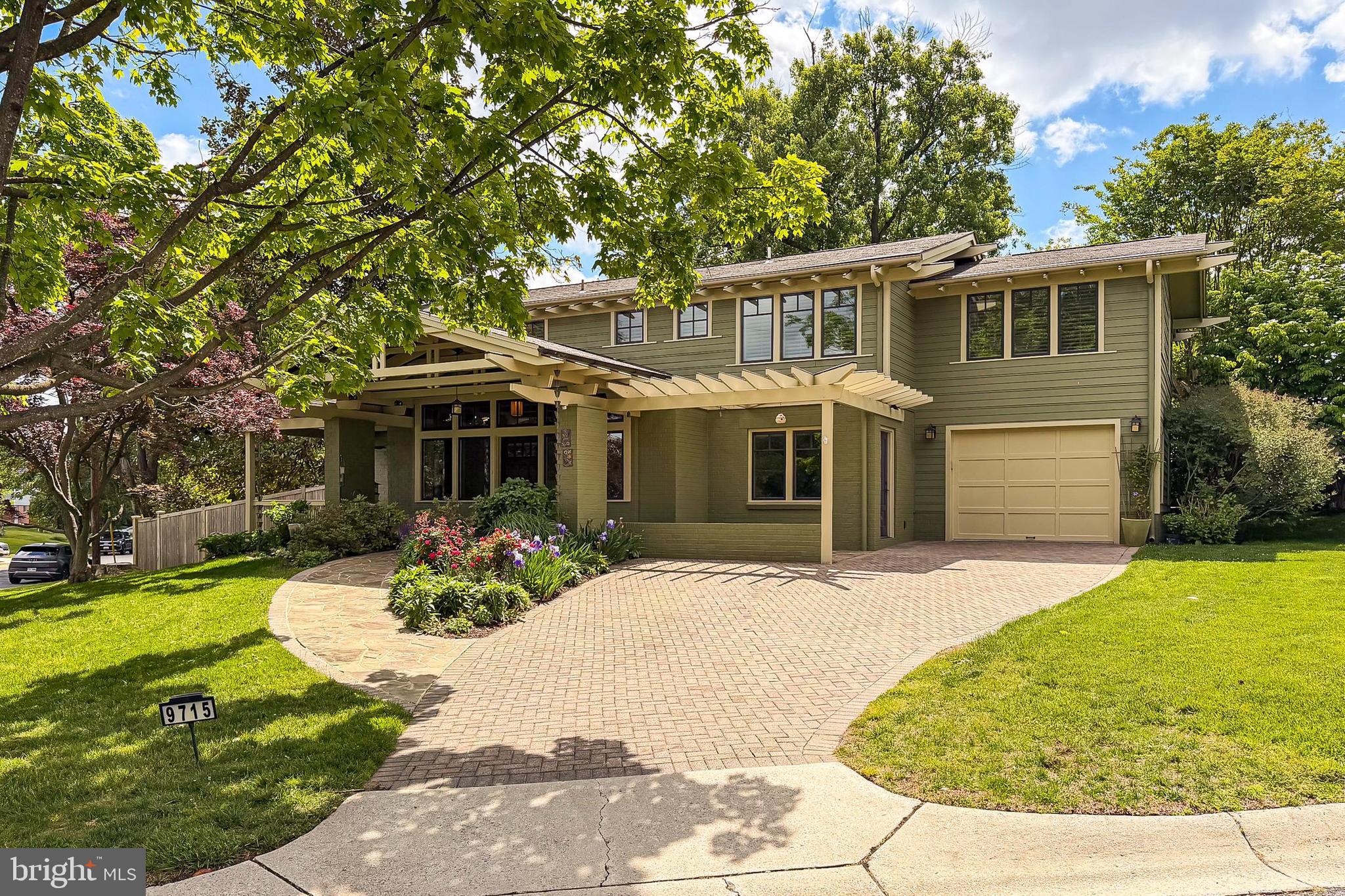 Qualified buyers may be eligible for Zero Mortgage Closing Costs, potentially saving thousands at closing! Set on a beautifully positioned corner lot just steps from nature, this exceptional home stands out with arguably the best curb appeal in the entire neighborhood and has been impeccably maintained and features brand new carpeting in the lower level! Originally built in 1959 as a Colonial, this gorgeous 4-bedroom, 4.5 bath home was fully renovated and transformed in the Arts & Crafts style in 2013 by DC architect JC Cummings. Freshly painted inside and out, the home offers three finished levels of thoughtfully updated living space infused with countless upgrades. ***** A striking brick and Hardiplank exterior with a custom brick paver driveway, 1-car garage, slate walkways and covered front and side porches, expert landscaping, covered rear porch, large stone patio with stacked stone sitting walls, and a lush, fenced backyard surrounded by trees and privacy plantings create instant outdoor appeal. ***** Inside, you’ll find an open floor plan, oak hardwood flooring, decorative moldings, custom built-ins, high ceilings and an abundance of easy to open and clean windows in every room filling the space with natural light. An open foyer with a soaring ceiling and walls of windows welcomes you, as rich hardwood flooring flows into the spacious living room with built-in oak bookcases, the family room/office with a cozy fireplace and the dining room accented by chair rail and chic pendant lighting. The adjoining kitchen remodeled in 2021 features an abundance of 42” white cabinetry, gleaming quartz countertops, designer tile backsplashes and stainless-steel appliances. The breakfast area features a custom-built table with matching quartz top and serving/bar area. Step outside to the porch, patio and expansive, private backyard that is a peaceful retreat—perfect for relaxing and entertaining. A powder room and a huge laundry/mud/pet room with supersized 2024 washer/dryer on pedestals and wood cabinets for extra storage complete the main level. ***** Hardwoods continue upstairs into the spacious primary suite with a soaring vaulted ceiling, walls of windows, a separate dressing area with built-in bench with storage, 3 large closets, an extra hidden closet, and a custom laundry chute. The luxurious marble and tile ensuite bath features a vaulted ceiling with skylights, heated floor, custom vanity with moveable sink mirror, a linen closet, water closet, and a huge frameless glass ultra-shower.  Down the hall, a junior suite enjoys a private bath, and two additional bedrooms share the hall bath, while the open loft/reading area can easily be enclosed as a 5th bedroom. ***** The finished lower level provides plenty of space for games, media, and exercise in the expansive multi-area recreation room. A 4th full bath adds convenience, and a second laundry room, unfinished workshop, utility room, loads of storage space, and a large enclosed extra storage area complete the comfort of this wonderful home that reflects true pride of ownership. ***** Ideally located near the Locust Grove Nature Center, Wildwood Shopping Center, Montgomery Mall, and major commuter routes including I-270 and I-495, this home combines suburban tranquility with everyday convenience. Enjoy easy access to Metro, top-rated schools, NIH, and Walter Reed, all while living in a warm, established community known for its charm and walkability. For a home with strong fundamentals, timeless appeal, expert renovations, and the perfect blend of space, style, and comfort in a stellar location, this is it! A few photos have  been virtually staged.