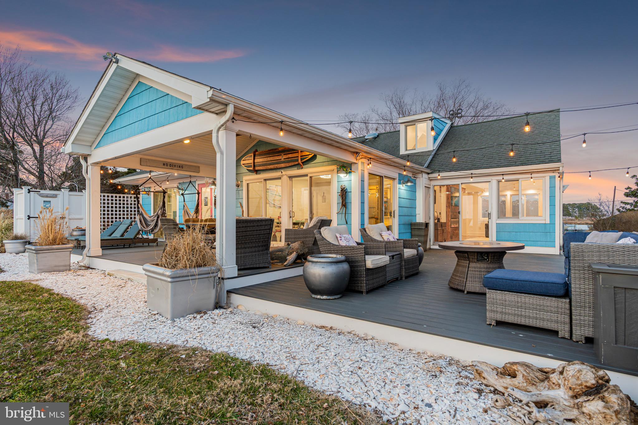 Experience elevated coastal living with this exceptional waterfront estate in Fishing Creek, Maryland, perfectly positioned on one of the island’s highest points—outside the AE flood zone—with water views and frontage on both sides of the property. This custom-built home offers approximately 2,400 sq ft of light-filled, thoughtfully designed living space that blends luxury with laid-back charm. Enjoy breathtaking sunrise and sunset views over the Chesapeake Bay from nearly every room, and step outside to your private extended dock with installed utilities, rip-rap shoreline protection, and direct access to boating, crabbing, and kayaking. Inside, the gourmet chef’s kitchen features quartz countertops, stainless steel appliances, and a custom driftwood island, opening to a spacious great room with floor-to-ceiling windows, natural shiplap, exposed beams, and a custom electric fireplace. The home includes three beautifully designed bedrooms—including a serene waterfront primary suite and a one-of-a-kind bunk room with built-in beds and captain’s quarters—plus two spa-inspired bathrooms with heated tile, Jacuzzi tub, custom tilework, and a heated bidet toilet. The outdoor deck and custom instant-hot outdoor shower offer the perfect place to unwind after a day on the water. A massive value add awaits in the temperature-controlled, oversized four-car garage with a built-in office and unfinished space above—ideal for a guest suite, studio, or rental potential. Surrounded by natural beauty and total tranquility, this is more than just a home—it’s a rare opportunity to own one of the Eastern Shore’s premier waterfront locations. Schedule your private showing today and see why this is the ultimate coastal retreat.