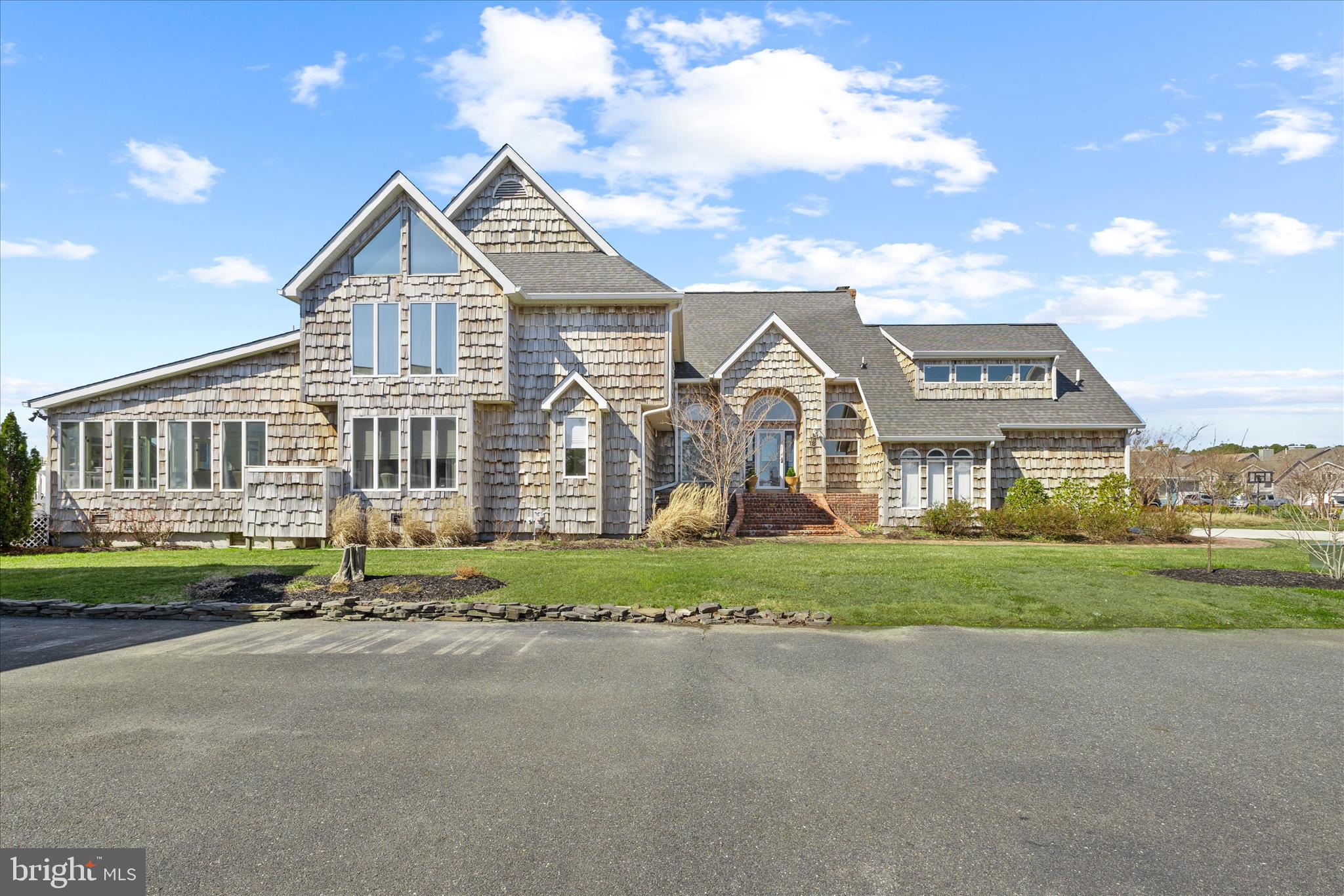 The distinctive design and standout coastal architecture of this 7-bedroom, 4.5-bath waterfront home evoke timeless Hamptons elegance while embracing relaxed Eastern Shore living. Perfectly positioned in the prestigious Wood Duck II section of Ocean Pines, this exceptional waterfront retreat offers direct access to the St. Martin River and the bay, complete with a private dock and boat lift , offering easy bay access for boating to Ocean City, waterfront dining by boat, and peaceful sunset cruises from your own private dock.

Designed with both entertaining and everyday comfort in mind, the home features expansive living areas including one formal living room and two spacious family rooms, complemented by two fireplaces and soaring ceilings. The generous scale and thoughtful layout create the perfect setting for hosting large gatherings while still offering private spaces throughout — truly room for everyone. The open, airy floor plan is enhanced by expansive windows that flood the interiors with natural light and frame sweeping water views from multiple vantage points.

Cedar siding and a brand-new deck (2025) complement the home’s coastal presence, while maintenance-free Trex decking provides generous outdoor living space overlooking the water. The in-ground heated pool creates a true resort-style setting ideal for summer entertaining.

Inside, the updated kitchen showcases granite countertops, wood cabinetry, and new appliances (2023), seamlessly blending function and style. Additional upgrades include a new roof (2025), newer HVAC, new high-grade bedroom carpeting, refreshed bathrooms, updated flooring, and Andersen sliding glass doors that enhance energy efficiency and indoor-outdoor flow. The home is beautifully styled with refined coastal finishes throughout, creating a bright, cohesive, and welcoming atmosphere in every room. Abundant storage throughout adds both practicality and flexibility.

Whether envisioned as a primary waterfront residence, refined second home, or luxury rental investment, this property delivers scale, comfort, and exceptional boating access. Home is currently a luxury Airbnb rental with very high income potential. Contact agent for link. 

Residents of Ocean Pines enjoy walking trails, four community pools, a yacht club with waterfront dining, marina access, beach club, parks, sports courts, and year-round activities — all just minutes from historic Berlin and the beaches of Ocean City.