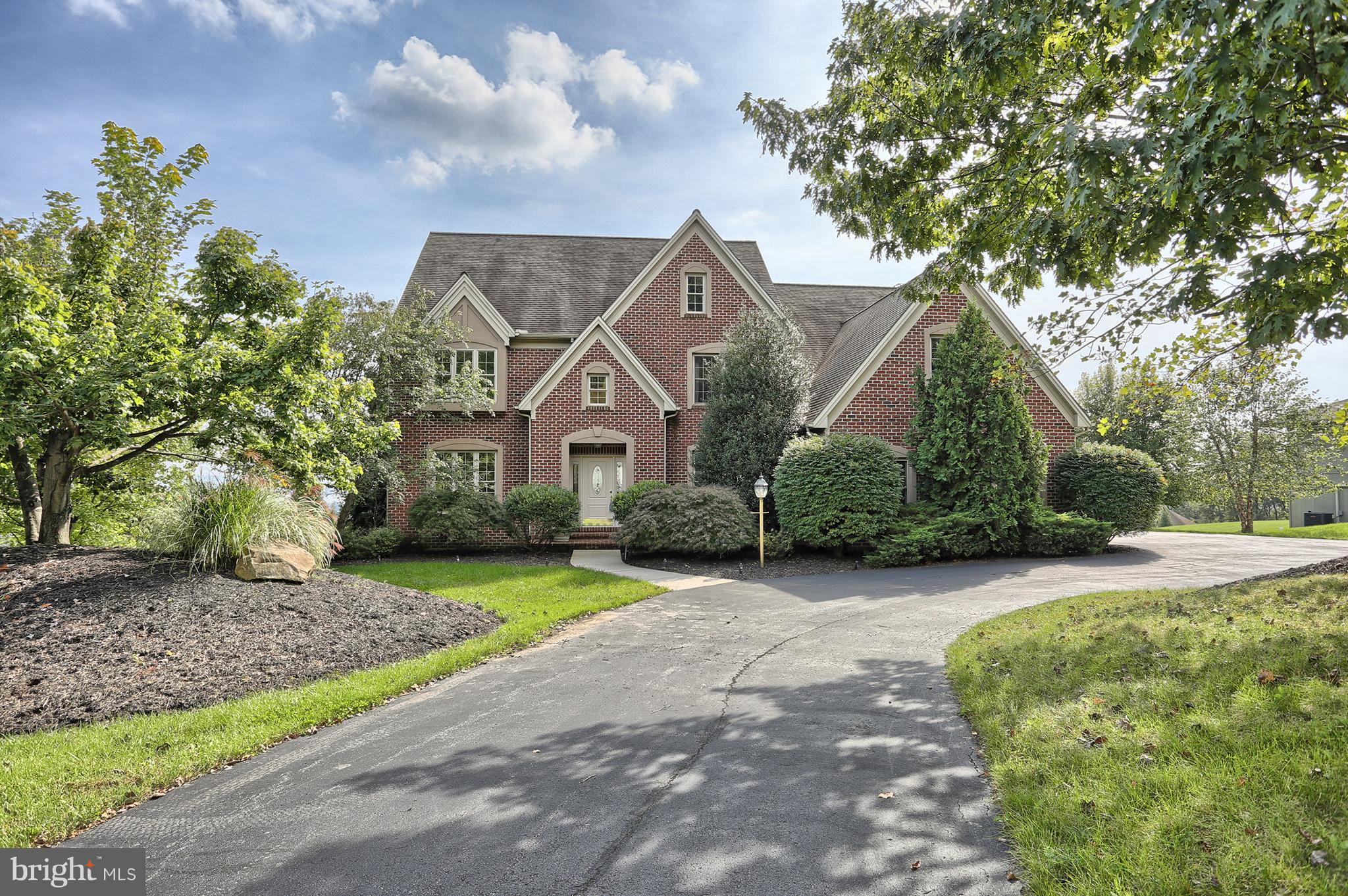 Million Dollar Views!  Sit on the 85 ft deck and take in the breath-taking panoramic views of Harrisburg and beyond. Enjoy the fireworks from City Island all summer long from the best seat in the house! This all-brick stately home is situated on the best lot in the exclusive River Bend neighborhood and offers over 5600 square feet of living space.  Surrounded by trees and nestled on the side of a mountain, this is a one-of-a-kind home, with one-of-a-kind views.  Originally the spec home of Builder Jim Miller, this home offers many upgrades. The 2-story great room has a wall of windows overlooking the spectacular views of the city.  The eat-in kitchen also includes a center island for additional seating and counter space.  A large pantry and an abundance of cabinets provide tons of storage. A Sun Room, just off the great room could be used as a unique office space, or a quiet sitting room.  The formal living and dining room complete the expansive first floor.  Upstairs, the spacious master suite, with windows looking out to the amazing views, includes a completely renovated master bath with a Kohler jetted tub, oversized walk-in, tile shower with rain head and an enormous walk-in closet.  Three additional bedrooms, all with walk-in closets, a hall bathroom and laundry room finish off the 2nd floor.  The lower level adds an additional 1,700+ square feet of living space, includes a custom stone fireplace, custom bar area as well as space for a gym and a full bathroom.  Full in-ground irrigation system in the yard was installed in 2002 and includes option to add fertilizer and weed control.  A flat grassy area is perfect for a pool, and a private concrete pad is wired and ready for your hot tub.