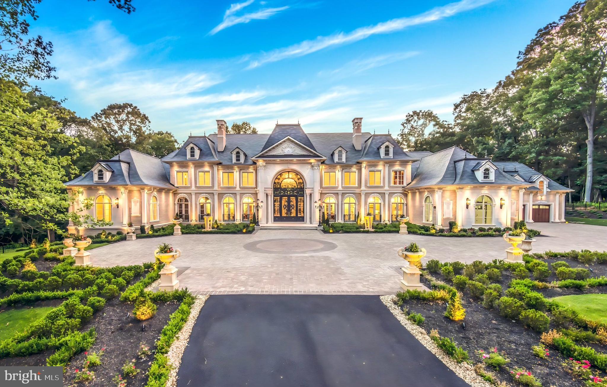 Welcome to a realm where elegance, craftsmanship, and globally renowned design converge to create the extraordinary haven of Château de Lumière. This amazing home was meticulously designed and built by The Building Group, with uncompromising finishes and flawless details. Inspired by the finest traditions of European architecture, with over 20,000 square feet, it is prominently positioned on 5.5 fully secured, secluded acres with mature gardens. Unveil a world of uncompromising finishes, impeccable details and prestigious materials such as custom brick, cast stone, slate roofing, glass mosaics, plaster molding and imported marble. This residence has state-of-the-art electronics that enhance every corner, ensuring a lifestyle of modern sophistication that transcends expectations, meeting every contemporary desire with a floor plan ideally suited for both family living and grand-scale entertaining. The Main-Level with 12-foot ceilings has a grand and welcoming Foyer and Gallery. There is also a gracious and expansive Living Room, Dining Room, Library, Ball Room, Bar and a luxurious Bedroom with Bath. At the heart of the home is a luxurious Chef’s Kitchen with the finest custom cabinetry, appliances, fixtures, a Spice Kitchen and gorgeous Family Room. The Upper-Level expansive Owner’s Suite is privately positioned with sweeping views of the pool and gardens. There are also 4 additional generous ensuite Bedrooms. The walk-out Lower-Level is spectacular and includes a Recreation Room with fireplace, Billiards Room, Bar & Wine Rooms, Theater Room, Spa, Club Room, Massage Room with Sauna & Bathroom and a private Guest Room with Sitting Area and Bath. Elevating the Lower-Levels allure is an Indoor Basketball Court with almost 16-foot ceiling! The property includes a 6 car garage with a detached Guest Apartment above the 3 car garage. The lush formal landscaping transcends the ordinary with a sparkling pool and encircling fire bowls harmonizing the elements of fire, air and water. This monumental estate, situated just beyond the bustling city of Washington, D.C. in the prestigious Great Falls, Virginia, is a testament to opulence and grandeur.