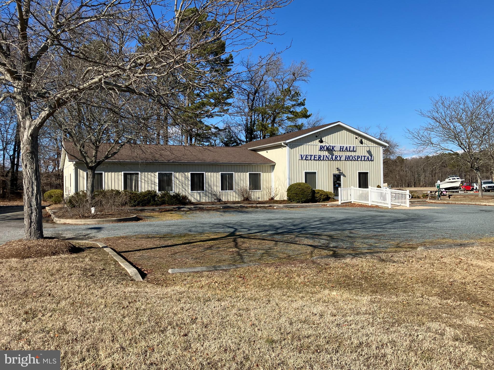 This 3,000 SF commercial building was originally constructed in 2001, but was significantly improved in 2020 and most recently used as a veterinary hospital. A 29 ft x 16 ft reception area, 8 treatment rooms/offices and 2 restrooms offer a user-owner or investor a flexible layout for a variety of uses. Dual heat pumps with propane back up provide multi-zoned conditioning for the building. Two ADA compliant bathrooms and an entry ramp are in place. There are sealed concrete floors in the work spaces and new high quality vinyl planked flooring in pubic areas. A 5KW Generac back up generator insures uninterrupted power to the building. The property is served by public water and sewer and there is a whole-building water filter installed. Crossroads Commercial zoning offers a wide range of permitted uses. Conveniently located on Rt. 20, 5 minutes outside the town of Rock Hall.