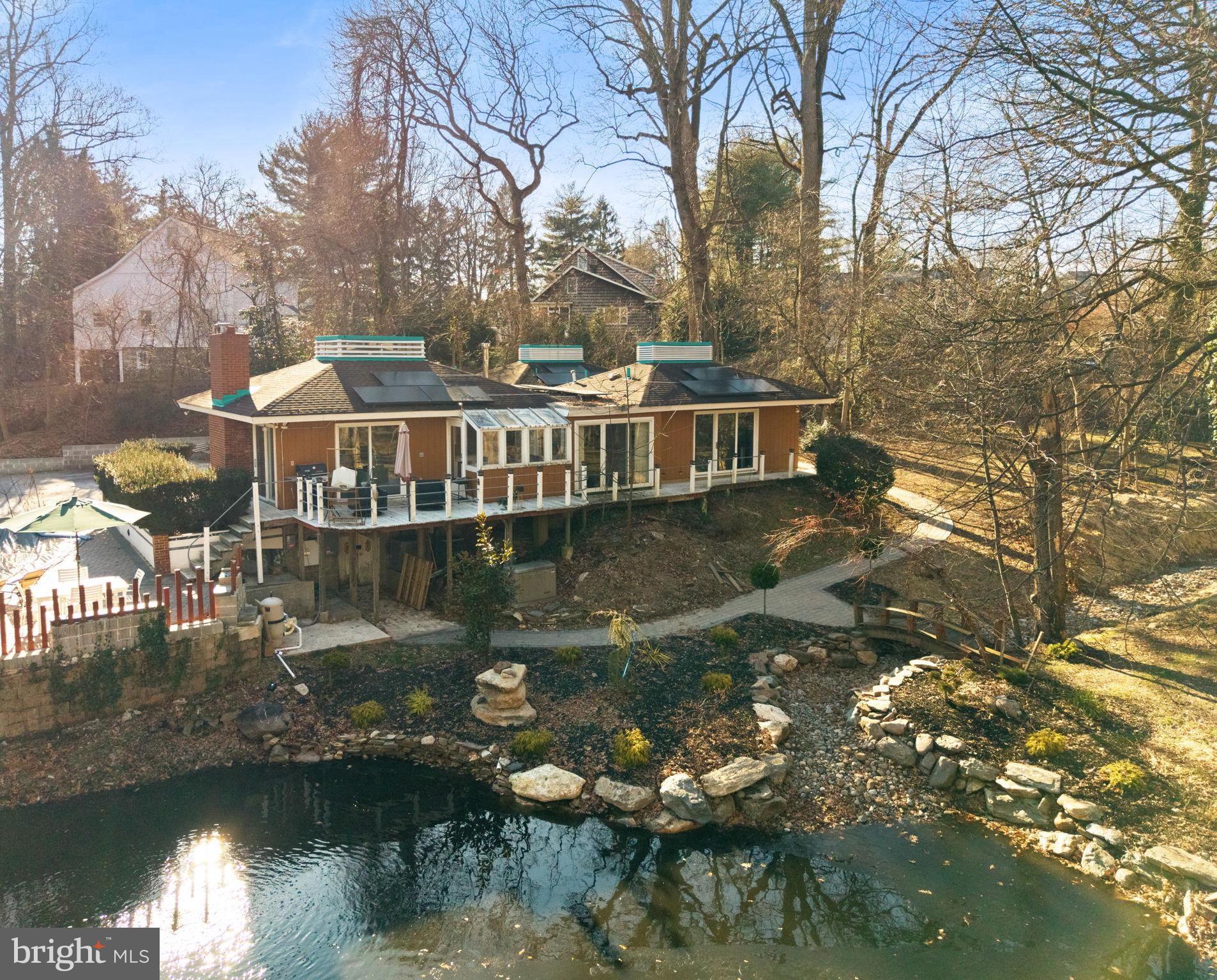 Mid Century Modern on over 1.5 acres in the charming Westover neighborhood in Yardley. The private, set back drive opens up to an oasis that includes an aerated pond, renovated inground pool, and fantastic outdoor space that makes this a truly special property. This thoughtfully updated 5 Bedroom, 3 Full Bath home offers unique design elements and wonderful natural light, and beautiful views from every room. Recent improvements include a Tesla power wall with solar panels for energy efficiency, freshly painted exterior, new tile entry, updated flooring, new driveway and concrete parking area, new primary and hall baths to include floating vanities, new kitchen appliances, new washer and dryer, solar lighting on the exterior, propane generator and new landscaping. Tucked amongst a tranquil back drop yet only minutes to the downtown shopping and dining in Yardley Boro, trains to Philadelphia and NYC and the I-295 corridor for commuting. A refreshing style within your own private sanctuary!