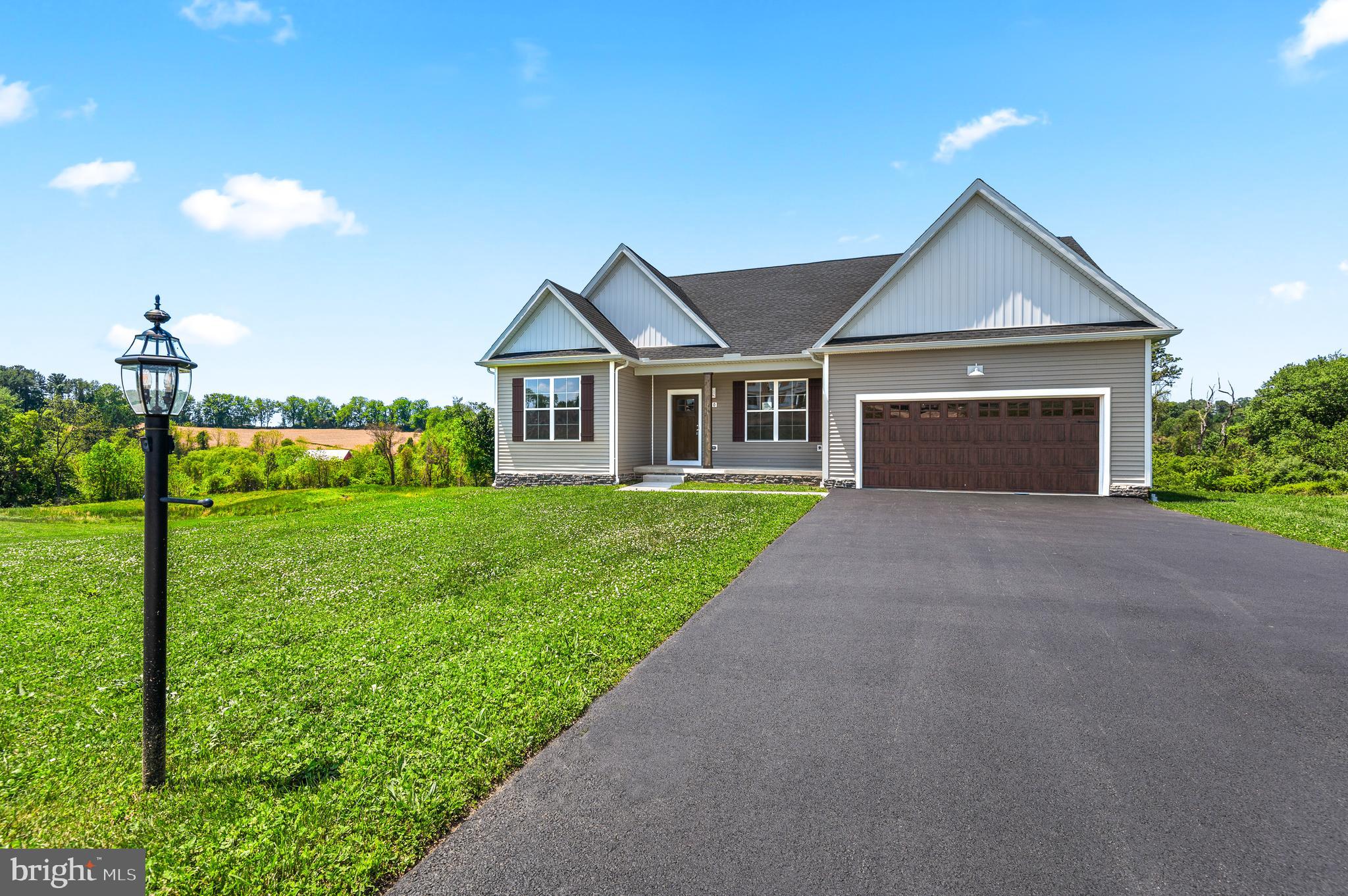 Welcome to Steeple Chase, an exclusive countryside community in Hanover offering spacious homesites, scenic views, and modern craftsmanship. Situated on over 2 acres, this move-in ready Yorktowne Rancher by Burkentine Builders combines the ease of one-level living with high-end finishes and thoughtful design.

Featuring nearly 2,000 square feet of living space, this home offers 3 bedrooms, 2 full baths, a private study, and an open-concept layout designed for everyday comfort and entertaining. The heart of the home is the beautifully appointed kitchen featuring quartz countertops, an oversized center island, pantry, stainless steel appliances, and abundant cabinetry. The kitchen flows seamlessly into the dining area and spacious great room highlighted by a striking tray ceiling and large windows that capture the surrounding countryside views.

The owner's suite is privately situated and features a cathedral ceiling, walk-in closet, and a luxurious ensuite bath with dual vanities, a soaking tub, and a separate tile shower. Luxury vinyl plank flooring, 9-foot ceilings, recessed lighting, and upgraded trim details add style throughout the main living areas.

The full walkout basement offers nearly 2,000 square feet of additional space ready for future finishing, storage, or hobbies. Outside, enjoy peaceful views of trees, pastureland, and the nearby stream from your expansive homesite while still being just minutes from shopping, dining, healthcare, and commuter routes.

Experience the perfect blend of privacy, convenience, and quality construction in one of Hanover's most desirable new home communities.