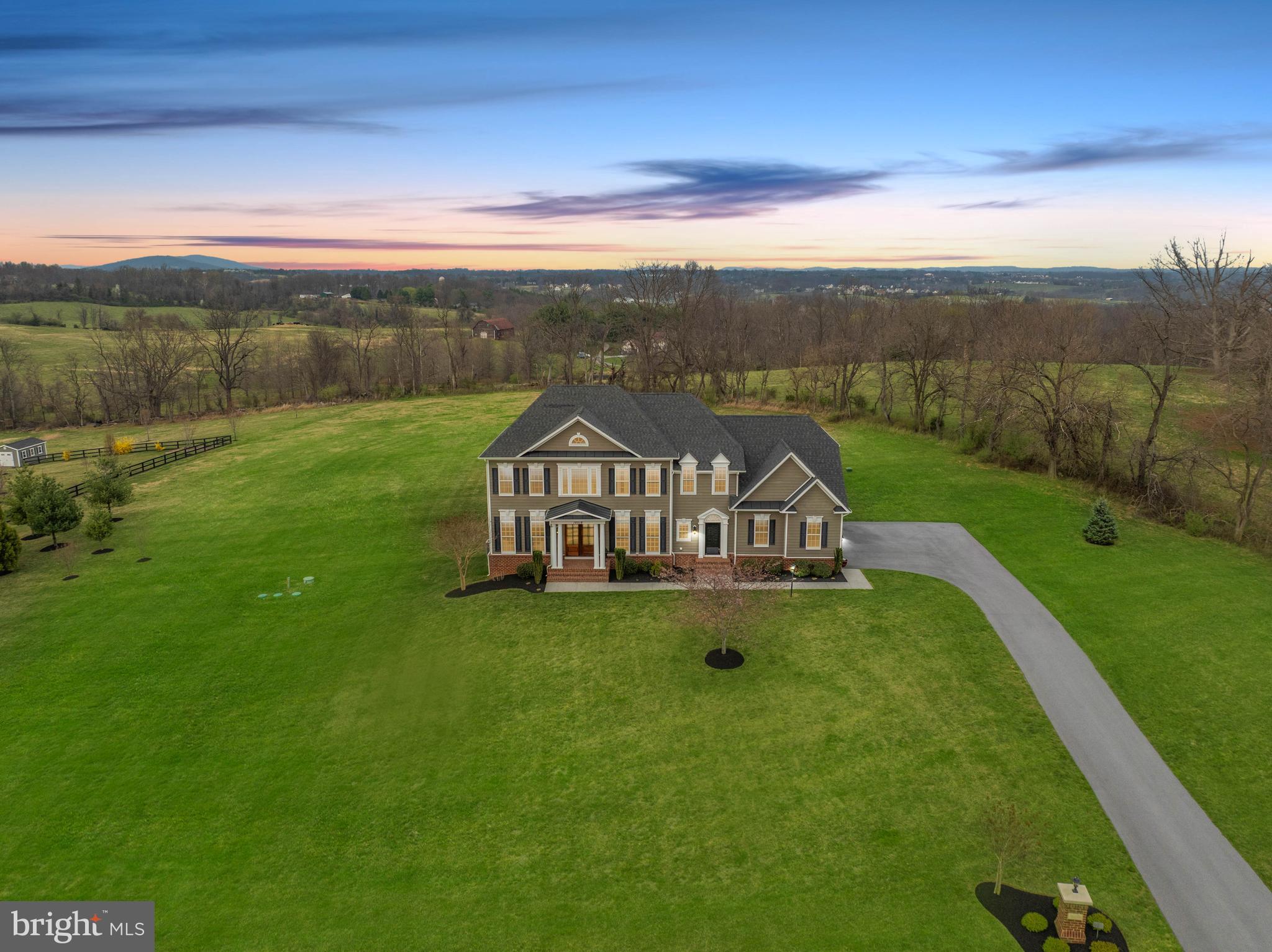 The perfect 10 home for sale in Purcellville, VA! This amazing semi -custom built home by Carrington  Builders is the Kendal Lane Model offering over 6000 sq ft of luxury finishes inside and out. Set on 3.11 acres in sought after Black Oak Ridge this home offers luxury finishes like  9' Mahogany double front doors and Hardi-plank exterior siding to exquisite trim detail  and wide plank engineered wood flooring. Loaded with options like 10' ceilings on the main level, coffered ceiling in the family room,  the keeping / sunroom off the kitchen, the extended kitchen counter and cabinetry for storage. A large island and private Trex deck overlooking the beautiful Blue Ridge Mountains. The spacious gourmet kitchen has  Island seating,   double ovens, cooktop with hooded vent,  a  built in microwave, a side coffee cocktail bar,  Arched wall accents lend an open but cozy feeling to the kitchen and family room space.    There is a main level office, a spacious living room, and separate dining room with beautiful trim detail. Tall transom windows bring in loads of natural lighting.   The  mudroom area off the kitchen  has a  a large pantry closet, a  washer/ dryer space and back staircase for easy access. The Upper level has hard woods in the hallway.  A primary suite that  features a cozy  sitting room and tall  palladian style  windows looking over the mountains. 2  large walk in closets. plus a  linen closet.  A spa bathroom with a separate soaking tub and 2  extra long vanities, A walk-in shower with 2 shower heads, 2 tiled inlay shampoo shelves and  2 bench seats. There are 3 additional bedrooms- an Ensuite bedroom (with a private bath) and 2 bedrooms that share a Jack and Jill bath.  The lower level is fully finished with a 5th bedroom and full bath - perfect for guests. A walk out door to the yard.  A huge recreation room with a pool table and entertainment space with wired surround sound. A wet bar rough in for  adding a future bar and a hobby / bonus room. The back yard is very open yet lined  in back with trees for a private feeling.  Newly installed water filtration system.  High speed internet. 3 Car side load garage with additional space for storage.  This home is a must see  home, very well maintained.