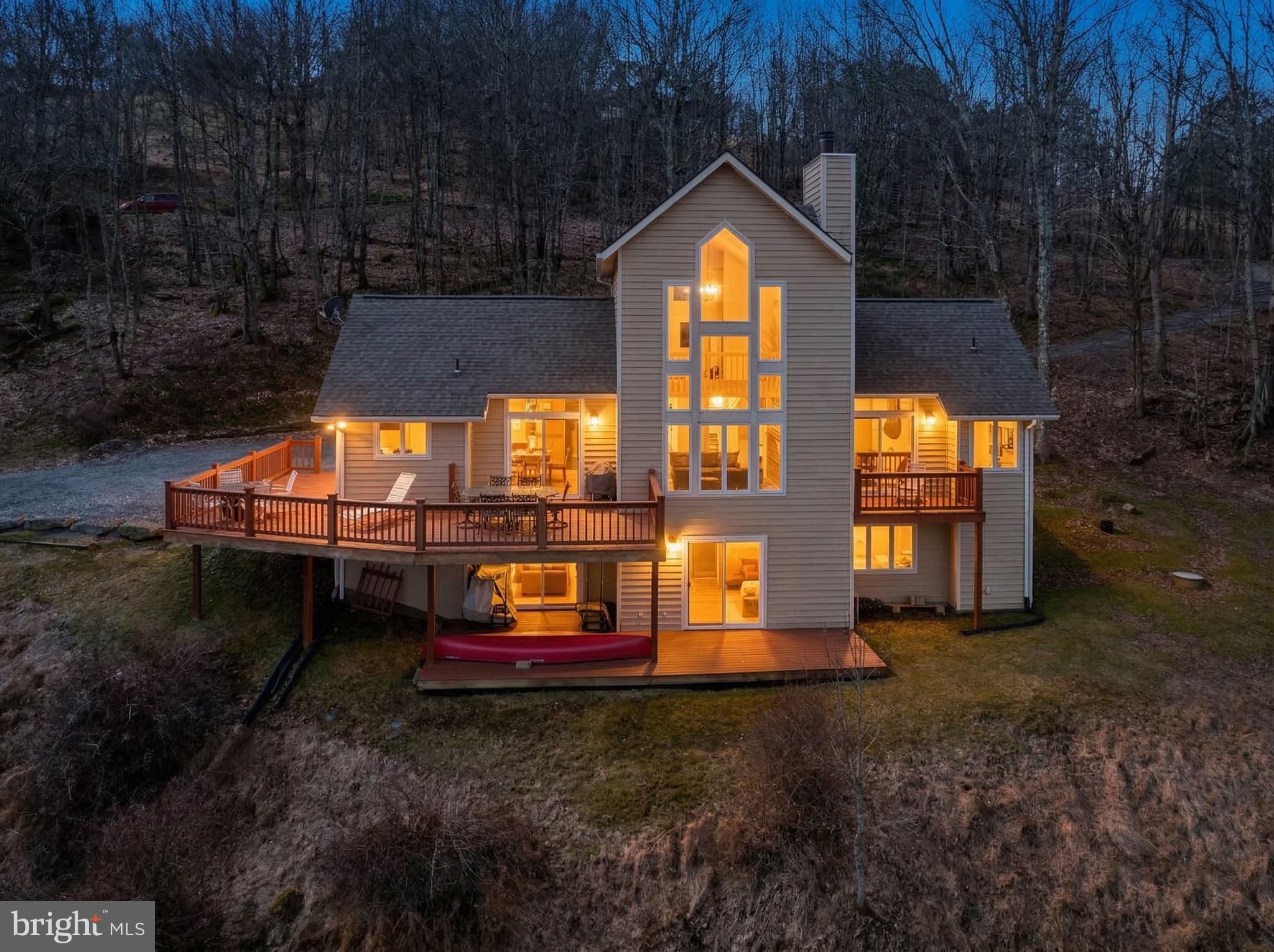 Experience mountain living at its finest in this breathtaking mountaintop home overlooking Deep Creek Lake. With sweeping views from almost every room, your hardest decision may be where to sit to enjoy them. Offering three levels of living space, hardwood floors ( which were recently refinished), and some new appliances. The multiple decks are ideal to enjoy family and friends while taking in the beauty around you. The location is another plus, just minutes to the community club house where you can enjoy the lake, and minutes to Wisp Ski & Golf Resort, restaurants, coffee shops, cinemas, and grocery stores. Class A lake access. Call today to preview!