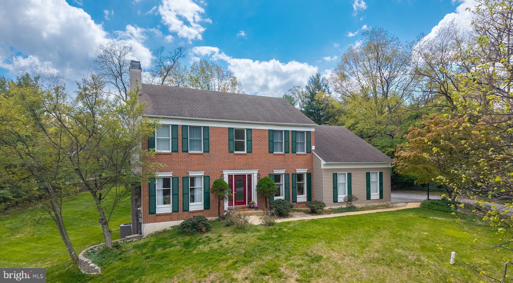 Set on a generous 0.75-acre lot in a private setting within the sought-after Whitford Ridge community, this 4-bedroom brick front home offers two fireplaces, hardwood floors on first and second floor, updated bathrooms throughout, and the low taxes and top-rated West Chester Area School District that make this corner of Chester County so appealing. The updated glass front door opens into a home filled with hardwood floors that flow throughout the main level. The living room invites you to settle in beside a gas fireplace, while the dining room sets the scene for easy entertaining. A dedicated study offers a comfortable work-from-home space. The kitchen features granite countertops, a granite island, stainless steel appliances including a gas range, and an updated patio door that opens to the paver patio with views of the pergola - a lovely spot to relax or entertain outdoors. The adjacent family room with vaulted ceiling, brick fireplace, and bamboo flooring is filled with natural light from a triple window and flanking windows on either side of the fireplace, offering a pleasant view of the outdoors. An updated powder room and a laundry room with utility tub and newer door to the garage round out the first floor. Newer hardwood floors run throughout the second level. The primary bedroom features a walk-in closet with organizer and a fully updated bath with frameless tiled shower, granite vanity, and soaking tub. Three additional bedrooms - two with closet organizers - share a remodeled hall bath with marble vanity and tiled shower. The finished lower level adds 700 square feet of versatile living space with a  tiled floor, an updated patio door to the side yard, and two separate storage rooms to keep everything neatly organized. Whitford Ridge is a wonderful community with a convenient location close to major routes, train stations, shopping, dining, and everything Chester County has to offer - all with low taxes and the highly regarded West Chester Area School District. Schedule your tour today - this one is worth seeing in person.