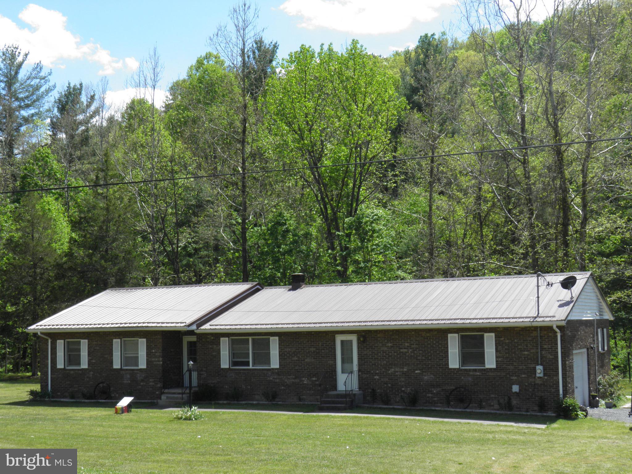 1,864 sf brick rancher with an 18’ x 20’ built-in garage, situated on 2.01 beautiful, level acres. This spacious home includes 3-4 BR and 2 BA with both EFA and EBB and CAC.  Appliances convey. Public water. Peaceful setting for private enjoyment or friendly entertainment with a creek, 20’ x 40’ pavilion, shed/privy, and brick fire pit.
