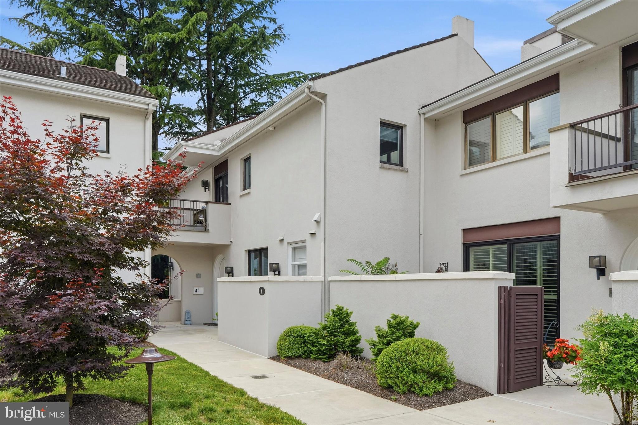 Welcome to 4 Dezac, a beautifully reimagined end-unit townhome in the highly sought-after Arbordeau community. Offering 3 bedrooms, 2.5 baths, a finished lower level, private elevator access to all three floors, and stunning garden views, this exceptional residence has been extensively renovated throughout with thoughtful updates and high-quality finishes.
The sun-filled main level features new hardwood flooring and an open and inviting layout.  Arched double doors welcome you to the fabulous one-of-a-kind space.  The entry foyer is spacious and offers access to a coat closet and a powder room. The oversized living room is highlighted by a rebuilt fireplace mantel crafted with granite and cherry wood. A custom granite wet bar adds both style and functionality, creating the perfect setting for entertaining. The beautifully renovated kitchen, completed in 2024, is open to the dining room and features granite countertops, stainless steel appliances, a spacious seated center island, abundant cabinetry, and seamless flow into the dining and living areas.
Large sliding glass doors from both the dining room and family room open directly to a beautifully landscaped patio, creating a seamless indoor-outdoor living space and providing the perfect backdrop for relaxing, dining al fresco, or entertaining guests while enjoying the picturesque gardens and tranquil views.
Upstairs, refinished original parquet floors add warmth and character. The spacious primary suite serves as a luxurious retreat, featuring a beautifully enlarged and renovated bath completed in 2023 with a soaking tub, double vanity, walk-in shower, and elegant finishes throughout. A walk-in custom-outfitted closet and private balcony complete this fabulous retreat.  Two additional bedrooms with ample closet space, one with its own balcony, share an updated hall bath with tub/shower combo. The finished lower level significantly expands the home's living space with a newly created family room featuring a walk-in closet, a dedicated laundry room, a large storage area, and a tiled entrance area, providing flexibility for recreation, guests, a home office, gym, or hobby space.
Outdoor living is equally impressive, with professionally landscaped gardens and patio areas designed to maximize the beauty of the surrounding setting. As an end-unit, it is the largest unit in the community, and the home enjoys exceptional privacy, abundant natural light, and picturesque views from every angle. The underground garage offers 2 parking spaces (each labeled #4).
Major improvements provide peace of mind, including all NEW: double-hung windows, four patio doors, two HVAC systems, water heater, electric panel, lighting fixtures, added recessed lighting and ceiling fans throughout, and extensive interior renovations completed between 2022 and 2024.
All of this set in the fabulous gated Arbordeau community, on approx 15 acres, with amazing amenities including a community pool, clubhouse, and even 3 guest suites. The association covers the exterior of the townhome as well as the roof and all common areas, guard house with attendants, and on-site manager.  The association also covers water, sewer, trash, Comcast cable, snow, and landscaping. 
With easy access to King of Prussia, the Main Line, and all major highways, the location can't be beat. Combining timeless character, modern upgrades, elevator access to all levels, beautiful outdoor spaces, and a desirable Main Line location, this move-in-ready home offers an exceptional lifestyle opportunity.