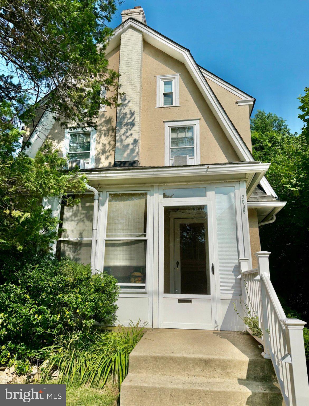 Nestled on a picturesque tree-lined street just three homes from Grasslyn Park, this charming three-story Dutch Colonial is filled with character and timeless architectural details. An inviting enclosed front porch welcomes you inside, where beautiful hardwood floors, original woodwork, and classic built-in cabinetry showcase the craftsmanship of a bygone era.

The spacious living room is anchored by a striking exposed Pennsylvania bluestone fireplace featuring a distinctive cowhide-style finish, creating a warm and memorable focal point. The formal dining room, highlighted by a beautiful triple window, flows seamlessly into a versatile family room filled with natural light, offering flexible space for a den, home office, library, or additional sitting area.

Just beyond the dining room, the bright eat-in kitchen offers abundant cabinet and counter space, a sunny breakfast area, and sliding glass doors leading to the deck and fully fenced backyard.

The second floor features three comfortable bedrooms and a beautifully remodeled hall bath with a double vanity, glass vessel sinks, a marble and stacked-stone accent wall, and a whirlpool soaking tub with a subway tile surround.

The finished third floor offers a private fourth bedroom complete with a ductless mini-split system for year-round comfort and ample space for both a sleeping area and study nook, making it ideal as a guest bedroom, home office, or private retreat.

The partially finished basement provides valuable additional living space with a recreation room, a dedicated hobby and craft room, a convenient powder room, a separate laundry area, and abundant storage.

Outside, enjoy a fully fenced backyard with a deck, patio, detached one-car garage, and a long private driveway providing ample off-street parking.

Conveniently located just a few short blocks from Eagle Road and Darby Road, the home also offers easy access to Route 476 (Blue Route), West Chester Pike, Center City Philadelphia, University City, shopping, dining, and everyday conveniences.

Offering timeless character, flexible living space, and an exceptional location, this inviting Dutch Colonial is ready to welcome its next owner.

Some listing photographs have been enhanced using AI technology for lighting, color, and image clarity. No structural features, room dimensions, or permanent property characteristics have been altered.