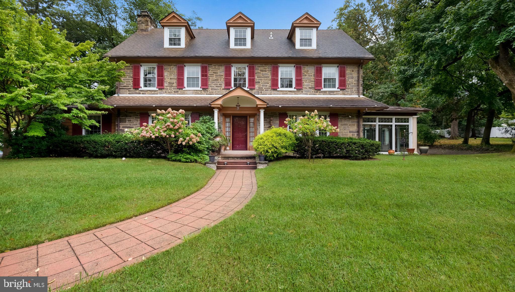 Nestled on a beautiful wooded .78-acre lot, this charming stone home seamlessly blends historic character with modern comforts. Custom-designed and built in the 1920s, the property boasts spacious rooms, high ceilings, deep windowsills, and pristine original woodwork, all bathed in natural light. The first floor welcomes you with a grand center hall, leading to a living room featuring a fireplace and an office with book shelves, and wood cabinets. A formal dining room with French doors opens to the serene patio., 

There are five generously sized bedrooms and 3 ½ baths, including a master suite. The home is 3,799 square feet and offers central air, gas heat, and backup oil heat for year-round comfort. The finished basement provides versatility, ideal for a home gym, game room, or in-law suite, complete with a full bathroom and laundry room.

Outside, enjoy a large in-ground heated swimming pool, a detached two-car garage, and a glass all-season porch. The backyard is perfect for outdoor entertaining, surrounded by mature trees for ultimate privacy. Located in the Cheltenham School District, the property is minutes from the PA Turnpike, Route 309, Arcadia University, and public transportation, with the Jenkintown-Wyncote Train Station offering easy access to Center City Philadelphia.

This home is truly an architectural gem, providing timeless elegance with modern updates. Don’t miss the chance to make it your own.