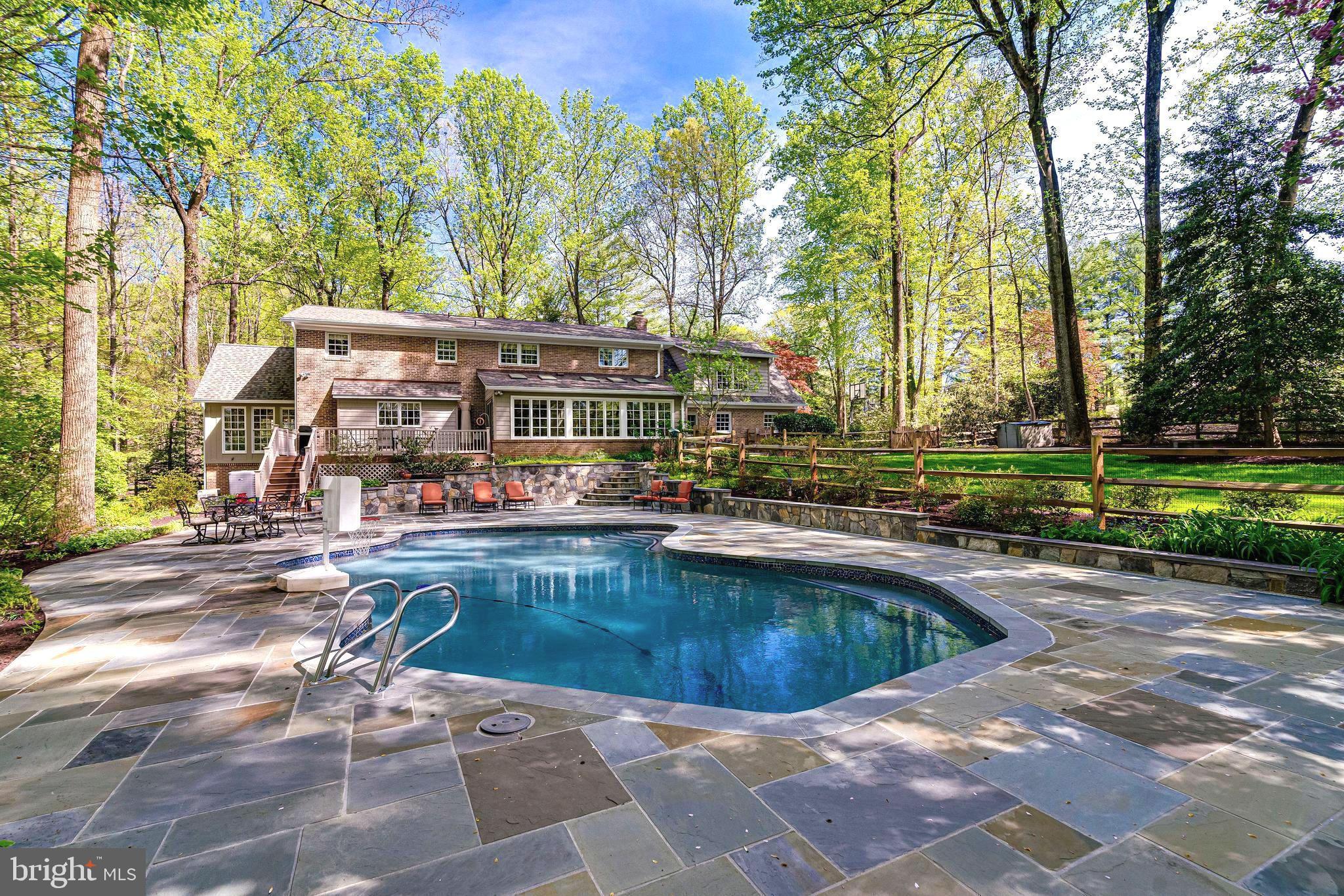 Rarely available 5-bedroom stately home in sought-after Oakton neighborhood, ready for move-in and summer pool side memories. Brick Colonial with amazing curb appeal, sun-drenched rooms throughout, two-story entry, huge chef's kitchen, and more. A major update in 2005 added a gorgeous formal dining room with three walls of windows, a second office space upstairs, built-ins for the main office/library, and a bright kitchen with TONS of cabinets and workspaces. Designed for easy-living, the home features a large laundry/mud room leading into a beautiful family room open to the eat-in kitchen which includes expansive counterspace, a walk-in pantry with a second fridge, and a separate butler's pantry/bar cabinet. Great for entertaining! From your kitchen window, look out onto your free-form in-ground pool with stunning stone walls and flagstone deck. Upstairs is the primary suite which includes a spacious walk-in closet with window (great lighting for wardrobe planning!) and a roman-inspired primary bath with jetted tub. Upstairs office with multiple workstations features glass doors allowing light to flow between the back and the front of the home. Four more bedrooms are also on this level plus two full baths (one with double sinks!). Ample closet space in each bedroom and special features as well. Enjoy the hidden spaces in the bedroom with dormer windows and built-in cabinets in another. Storage galore with a walk-in linen closet and a second hall closet. Hardwood floors on main and upper levels. Walk-up lower level includes another full bath, immense bonus/rec room, a separate media room with three windows, and new carpeting throughout. Property has professionally designed landscaping with mature trees and a large level grassy field. Flagstone walkways throughout. New roof and gutters installed in 2023, new attic HVAC unit in 2023 and systems inspected in April 2024, new garage door motor in 2022, new water heater in 2023, and septic pumped and inspected in 2022 (filter cleaned in 2024).

Neighborhood access to Cross County Connector Trail, close to Oakton shopping center, restaurants, Oakmont Rec Center, Vienna, Reston, Mosaic, Tysons, Fairfax, Vienna Metro Station, and major interstates.

Don't miss out on the chance to start making memories in this well-cared for home!