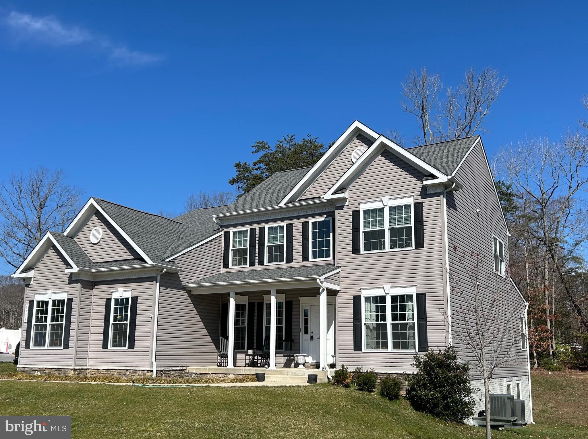 Beautiful 5 years young 6 Bedroom, 5 1/2 Bath Colonial. Features Two Car 8 foot door Side Load Garage with remote and blue tooth connectivity, Asphalt Driveway with additional Parking Area, Covered Front Porch and 21 X16 Rear Paver Patio. Formal Living and Dining Rooms, Two Story Entryway, Family Room with Gas Fireplace, Large Kitchen with Morning Room,12 foot Island, Walk-in Pantry, Tech Center, Quartz Countertops and GE Energy Saver Stainless Steel Appliances, Powder Room and Mudroom. First Floor En-Suite with Walk-In Closet, Upper Floor Owner's Bedroom boasts a separate sitting area, huge 150 sq.ft. his/hers walk-in closet, Large Bath with Separate Shower and Soaking Tub. Upper Floor also features an En-suite Bedroom plus 2 additional Bedrooms, Hall Full Bath and Laundry Room. Finished Walk-out Basement with Rec Room, Bedroom with attached Jack and Jill Bath, and an additional 1200 sq. ft. of unfinished storage areas, Conduit has been installed from the basement to the attic for future upgrades. Transferable 2-10 warranty. Minutes to shopping, restaurants and Solomons Island with an easy commute to DC.