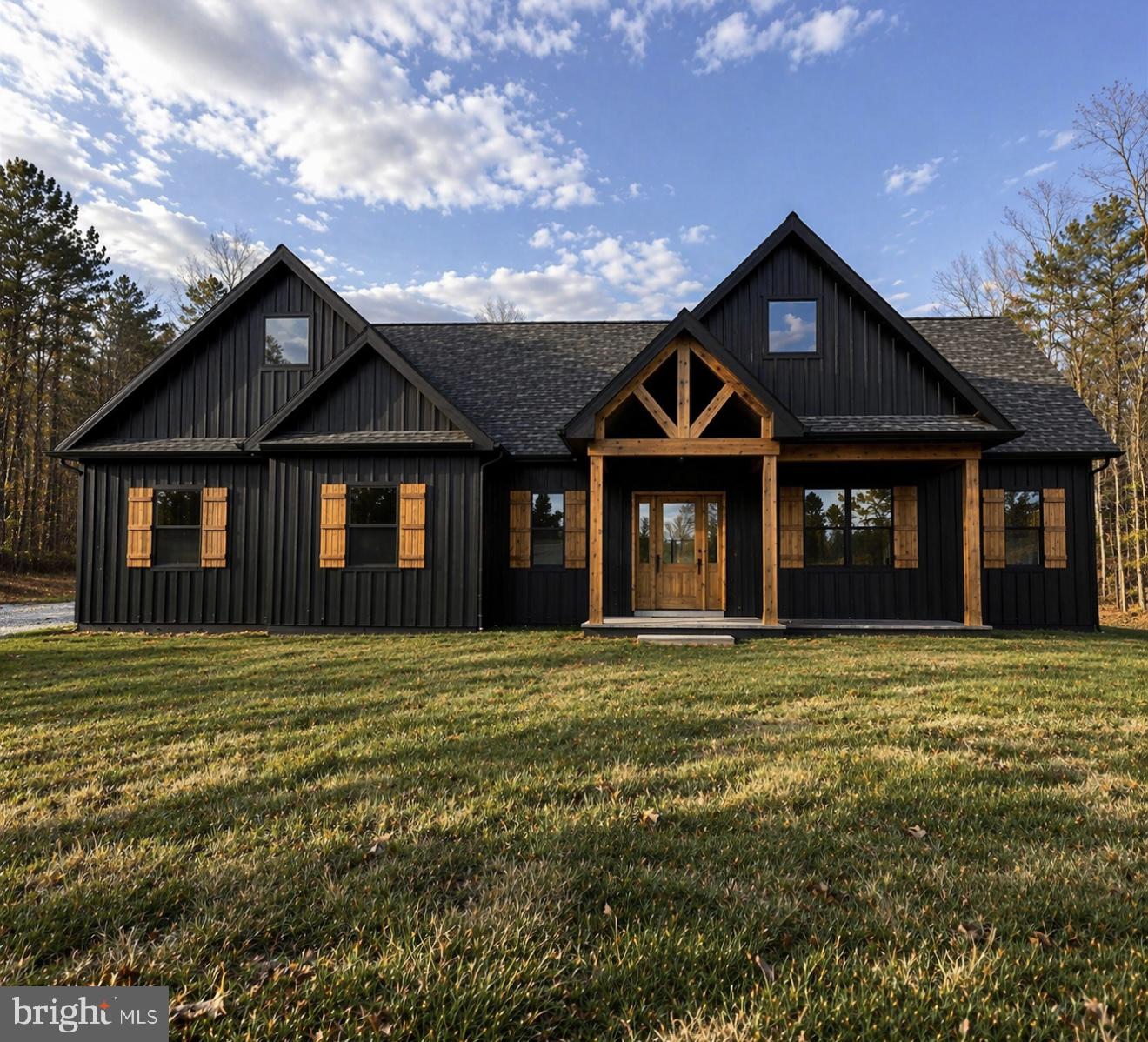 NEW CONSTRUCTION ***Construction has just started . Welcome to this stunning modern ranch-style home that is sure to turn heads. Where modern design meets peaceful countryside living on 2 beautifully situated acres.
Tucked back from the road for added privacy, this striking new construction ranch-style home offers a refined blend of modern style and natural surroundings. With black LP Smart siding in the front, rich timber accents, and cedar shutters, the exterior makes a bold first impression while seamlessly complementing the landscape.
Step inside to a thoughtfully designed open-concept layout spanning approximately 2,434 square feet, where clean lines, modern finishes, and natural light come together. The living room is anchored by a dramatic floor-to-ceiling stone fireplace, offering both a stunning focal point and a cozy gathering space.
At the heart of the home, the kitchen is designed to impress. A large statement island provides the perfect centerpiece for entertaining, complemented by a walk-in pantry, sleek cabinetry, and a full appliance package. Whether hosting guests or enjoying everyday moments, this space is both functional and beautiful.
The split-bedroom design ensures privacy, with a luxurious primary suite that serves as a true retreat. Enjoy a spa-like ensuite featuring a soaking tub, walk-in shower, and an oversized walk-in closet designed for both comfort and convenience.
Outdoor living is just as exceptional. Step onto the expansive Trex deck (approximately 18x12) and take in the peaceful surroundings—your backyard opens to a scenic 60-acre farm, offering views of pasture and distant mountains. The partially wooded lot has been cleared to create an open, usable space while still maintaining privacy and a natural setting.
The unfinished walkout basement, complete with rough-in plumbing, provides endless potential for customization—whether you envision additional living space, a home gym, or an entertainment area.
Located just under 20 minutes from Cacapon Resort State Park, you’ll have easy access to golf, hiking, fishing, and year-round outdoor recreation. Downtown Berkeley Springs is also a short drive away, offering charming shops, restaurants, and local amenities.
This is more than a home—it’s a lifestyle defined by space, privacy, and the natural beauty of West Virginia. Don’t miss the opportunity to make it yours. Picture is similar construction.