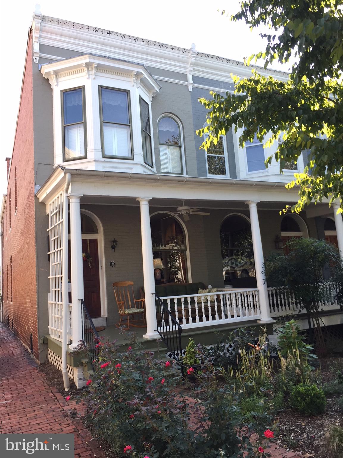 Historic charm meets modern luxury in this beautifully updated row home nestled in the heart of historic Frederick. This exceptional residence blends timeless architectural character with thoughtful renovations, featuring exposed brick walls, custom built-in cabinetry, and spotless,  original hardwood flooring that showcases the craftsmanship of a bygone era.

The gourmet kitchen is a true centerpiece, offering a stylish and functional space for everyday living and entertaining. The spacious primary suite provides a private retreat with a beautifully appointed ensuite bath, while the home’s inviting living spaces highlight the perfect balance of historic detail and contemporary comfort.

Step outside to the stunning ipe wood balcony overlooking professionally hardscaped perennial gardens, complete with a tranquil water feature creating a private oasis just steps from downtown. Enjoy peaceful mornings on the charming front porch with coffee in hand, or take advantage of the rare convenience of off-street parking.

Located in the vibrant community of historic Frederick, this remarkable home offers the best of city living—walkable access to boutique shops, acclaimed restaurants, local events, and the charm that makes downtown Frederick one of Maryland’s most beloved destinations. A truly special property where history, elegance, and modern living come together.