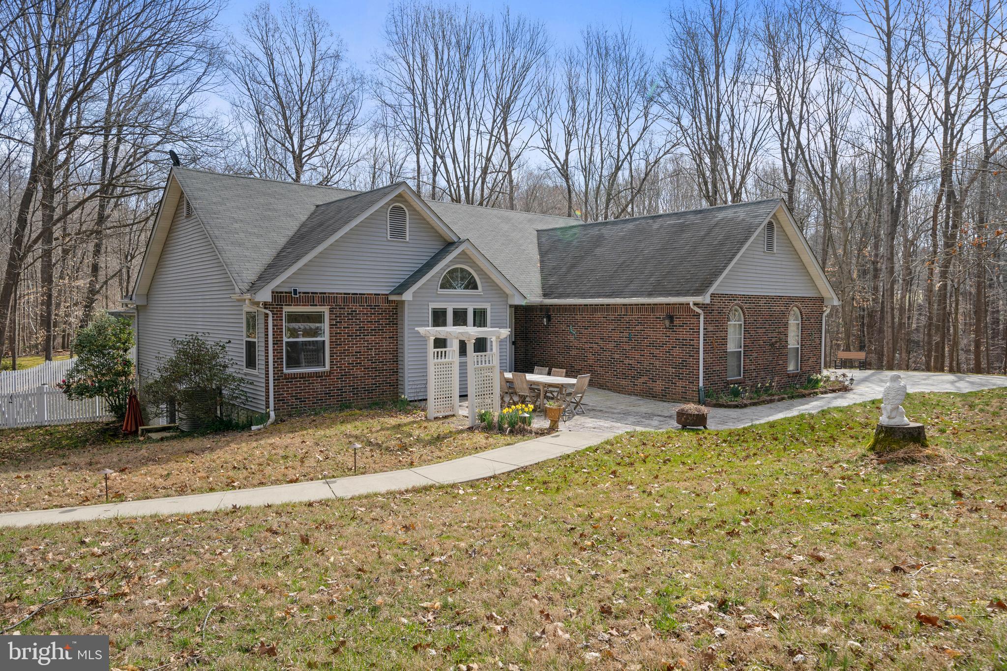 Well maintained rambler tucked away on 4+ wooded acres in Huntingtown. First level has two bedrooms and an owner’s suite.  Open floor plan with high ceilings and Brazilian Cherry Wood floors. The kitchen walks out onto a deck.  Separate laundry room is off the 2-car garage. The basement is finished with a second kitchen, a bedroom, and a full bath.  Great for the in-laws, house guest or potential income.. There is a stamped concrete patio. The detached two car garage is awesome for the vehicle enthusiast or additional storage. There is also a large shed.  This one won’t disappoint.