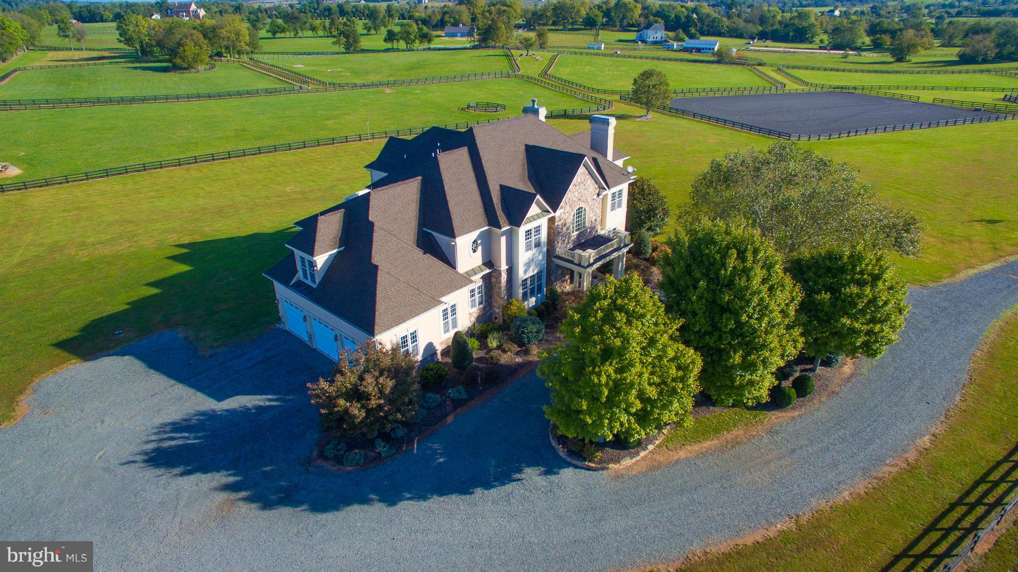 Must have appt, no drive bys. Stunning 25 ac, fenced/cross fenced with pristine board fencing. Buy now and enjoy spring hacking out, or schooling in your own 150x200 prof ring! 9/10ft ceilings. Peaceful master suite w/ spa bath, 18x17 dressing room w/ cedar closet.Walk out b'ment designed for in law/staff, room for media/wine cellar.Mud room w dog shower! 10 stall show barn, ring. Ride out.