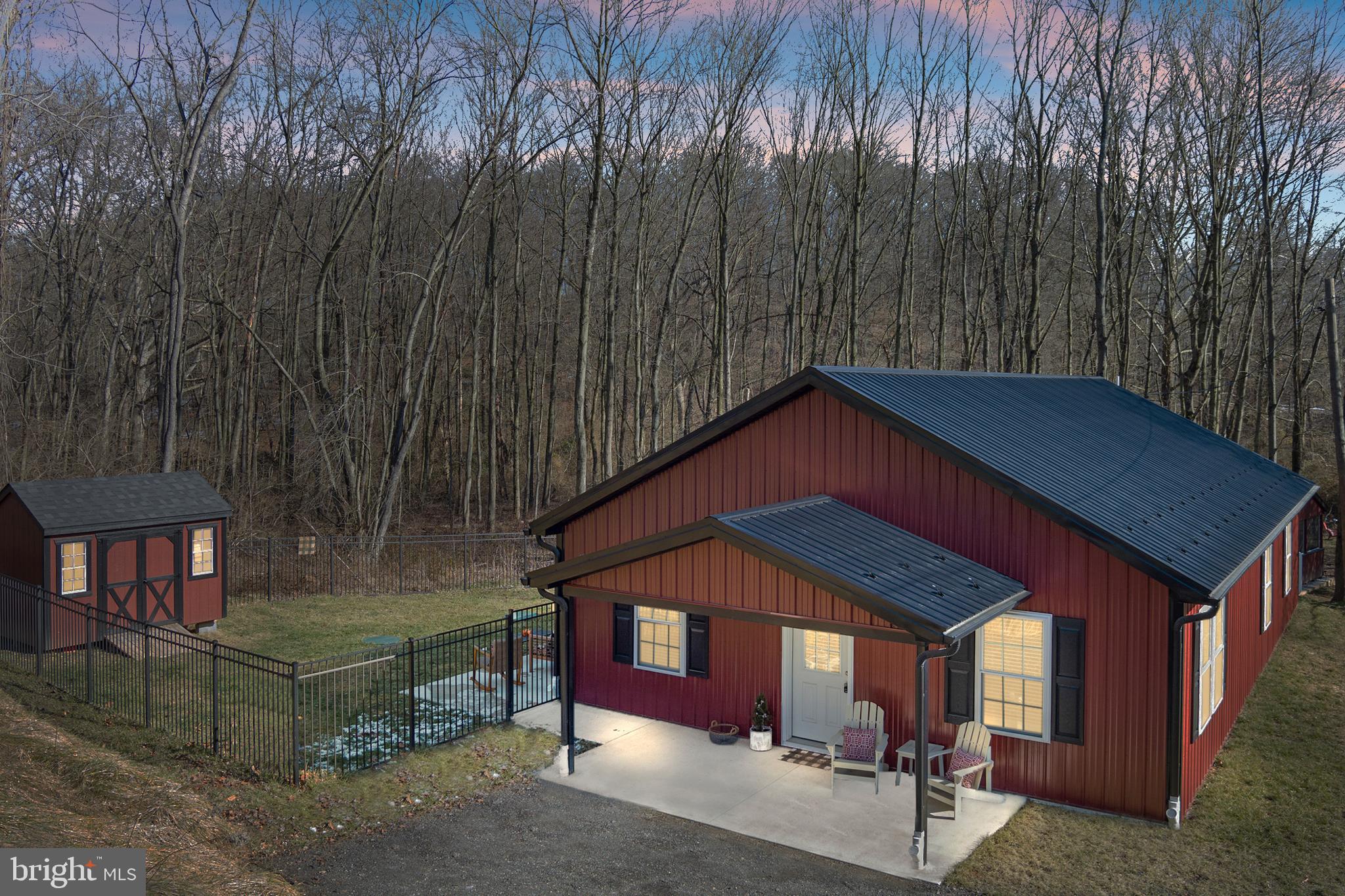 Welcome to 2 Robin Trail, Delta, PA - Built in 2022, this residence boasts 1,500 square feet of meticulously finished space, designed to cater to the desires of contemporary homeowners. This is a home that redefines modern living with its impeccable design and state-of-the-art features and amazing outdoor features!

The heart of this home is its main living space, which features vaulted ceilings and an open concept layout, creating an expansive and welcoming atmosphere. The interior is adorned with amazing styling and modern finishes throughout, ensuring every corner reflects sophistication and elegance.

Durability meets design with the home's exterior, featuring a metal roof and siding that promise longevity and minimal maintenance for years to come. The residence is equipped with a propane HVAC forced hot air system and central AC, providing comfort in every season with no immediate upkeep required.

Safety and privacy are paramount, addressed by a high-quality aluminum fence that encircles the property. Designed with small rungs and exceeding 5 feet in height, it ensures peace of mind for families with children and pets. Adjacent to the home, a storage shed, crafted by Amish artisans, mirrors the home's aesthetic, offering additional space in style.

The outdoor space is a true sanctuary, featuring a private stream, Neil Run, which meanders through the backyard. A quaint handmade bridge leads to a secluded seating area, perfect for entertaining, unwinding, or engaging in a spot of fishing in your very own stream. A swing adds a touch of whimsy and fun, making summertime in the yard a delight.

For an unparalleled outdoor experience, the property includes a stylish screened house in the backyard. Equipped with its own electric supply, a cozy seating area, and an electric fireplace, it's the ideal spot for entertaining or relaxing with a book, enveloped by the comforting ambience of a crackling fire.

2 Robin Trail is more than just a house; it's a haven that combines modern luxury, innovative design, and the serene beauty of nature. With its prime location and extraordinary outdoor features, this home is truly a rare find for those seeking a new, maintenance-free lifestyle in a picturesque setting.