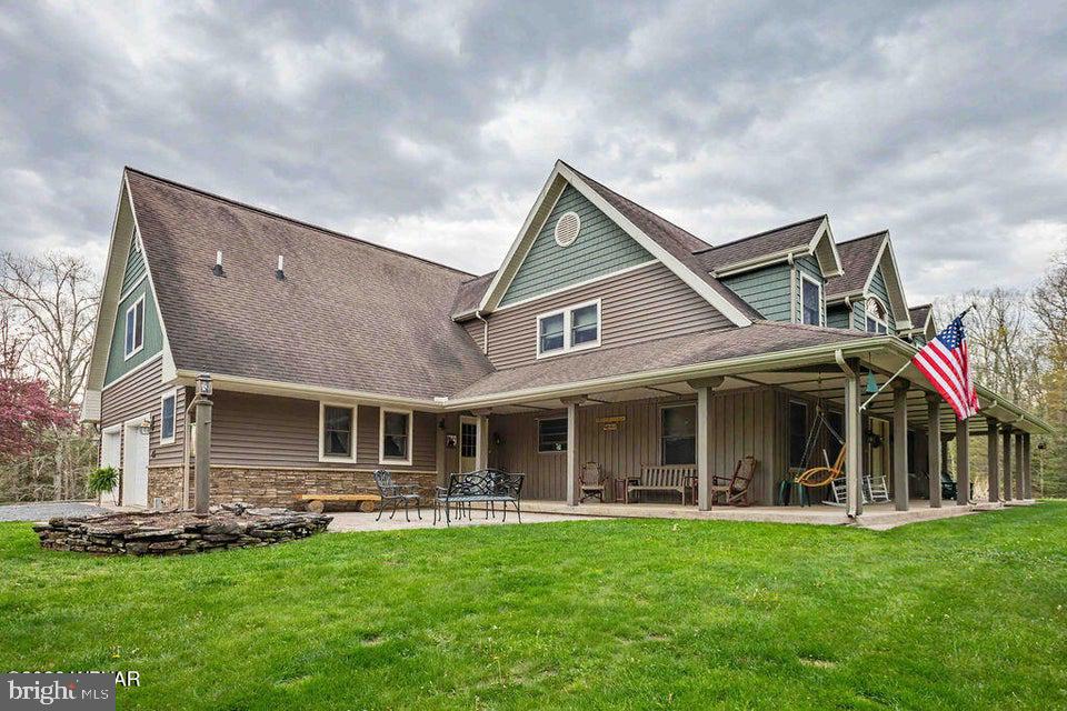 Experience unparalleled privacy and natural beauty in this sprawling country estate. Situated on 51+ acres, this home offers a rare blend of refined living and rugged outdoor adventure. A thoughtfully designed floor plan featuring 4 generous BRs and 4 modern BAs provides ample space for family and guests alike. The lower level with its cozy family room, office, workout room, workshop and kitchen area plus lots of storage is a bonus! Step out onto expansive porches and patios-perfect for morning coffee or hosting sunset gatherings overlooking your domain. The jewels of the property are two private ponds, offering opportunities for fishing or peaceful reflection. This entire property has been meticulously maintained and offers a level of tranquility that is increasingly hard to find. Contact listing agent Julia Randall (570)447-1300