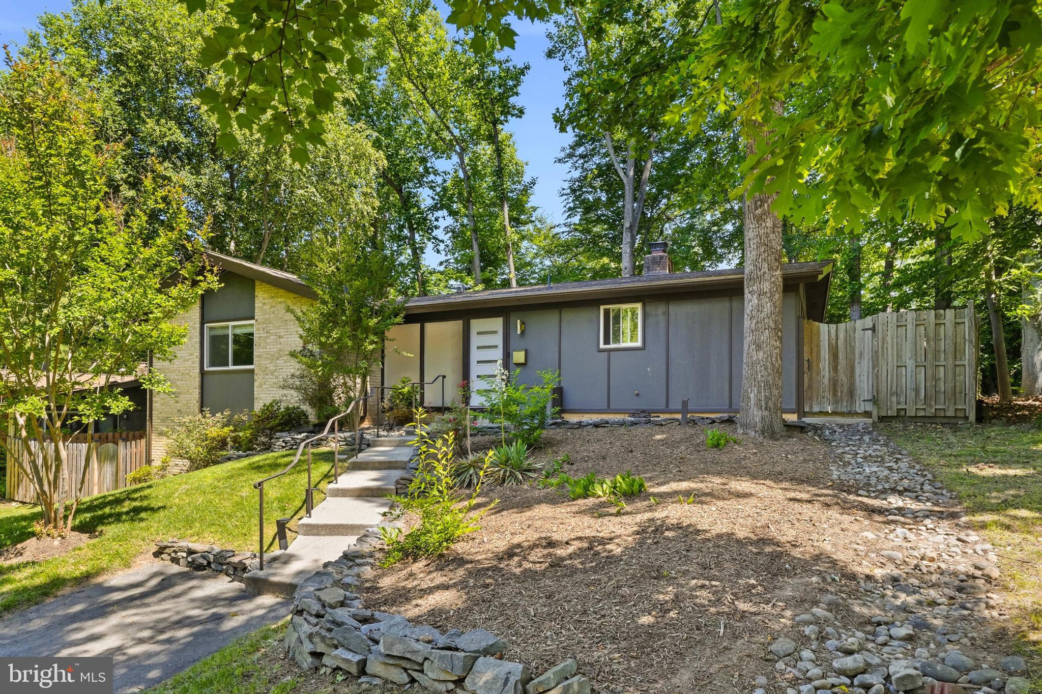 OPEN HOUSE SUNDAY JUNE 14th (2-4pm) ....Rarely available mid century modern located in the increasingly sought after community of Manor Woods! Designed by renowned architects Deigert & Yerkes, the sophisticated style  and architecture of this home is truly unparalleled! The timeless contemporary theme of this home has been preserved and blended perfectly with beautifully remodeled finishes! Natural sunlight pours through massive windows into an open concept main level living space that includes a stunning gourmet kitchen, a large dining area, and a relaxing living room with fireplace! Find two sizable guest bedrooms, a remodeled hall bathroom, and a private primary suite with ample closet space and an impressive en-suite bathroom! A finished, walk-out, lower level holds two additional bedrooms (or at home office spaces), an additional, fully remodeled bathroom, a finished laundry room, and plenty of storage space!  A private, fully fenced backyard features multiple entertainment patios and plenty of space for recreation or gardending! Prime Rockville location! Enjoy close proximity to area schools, Rock Creek Park trails, Rock Creek Village Center shopping, and Red Line Metro!