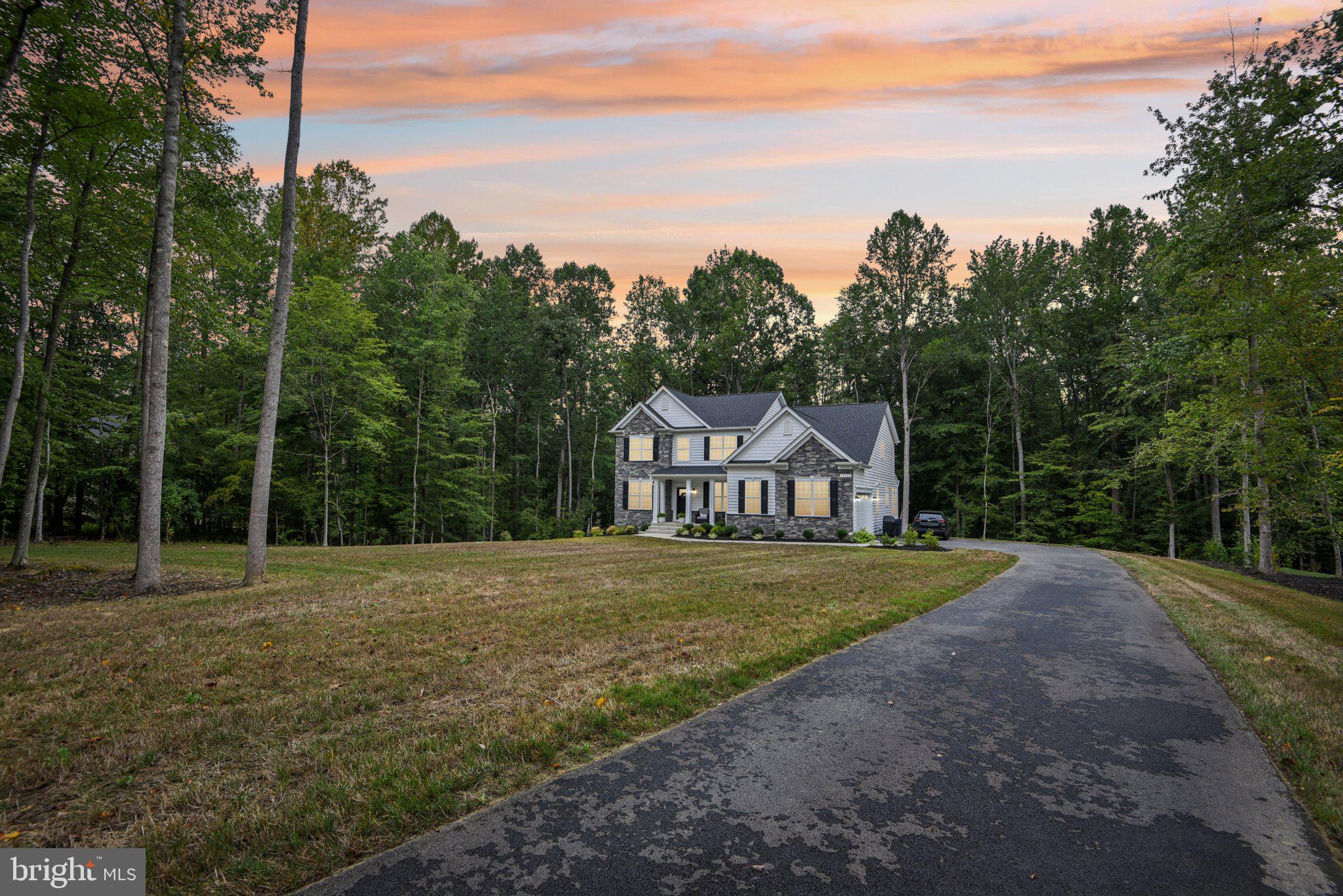 Your Dream Home Awaits!!! Why wait months to build when you can move into a fully upgraded, nearly new estate home today?

Welcome to 12130 Calverts Run Ct., an elegant stone-front Fairfax model by Quality Built Homes, beautifully situated on a private 1.29-acre homesite in the prestigious community of Fischer's Grant. Built in 2024, this exceptional residence offers over 4,500 finished square feet of thoughtfully designed living space with extensive builder upgrades and owner enhancements already completed. Skip the construction delays, upgrade costs, and uncertainty of building; this home is move-in ready!

Designed for today's lifestyle, the open-concept main level features a gourmet kitchen with quartz countertops, an oversized island, upgraded cabinetry, stainless steel appliances, beverage fridge, double wall ovens, cooktop, custom backsplash, and a spacious walk-in pantry. The adjoining breakfast area opens to a stunning family room with elegant coffered ceilings and a gas fireplace, creating the perfect space for everyday living and entertaining.

A formal dining room, private office, and a highly desirable main-level private suite with a full bath and walk-in closet make this home ideal for multi-generational living, extended guests, or a private home office.

Upstairs, the luxurious owner's suite offers a spacious sitting area, oversized walk-in closets, and a spa-inspired bath with dual quartz vanities, a soaking tub, and an oversized walk-in shower. Three additional bedrooms, a versatile flex room (for an upstairs laundry or exercise room, etc.), and a beautifully finished hall bath complete the upper level.

The fully finished walk-out basement adds exceptional living space, featuring a bonus room, full bath, large recreation room, and lots of storage. Perfect for entertaining, overnight guests, or a home gym.

Outside, enjoy the privacy of your professionally landscaped 1.29-acre homesite featuring front and rear irrigation, upgraded well capacity, a whole-house water filtration system, an oversized 2.5-car side-entry garage with EV charging capability, and outdoor spaces designed for relaxing and entertaining.

Conveniently located just minutes from shopping, dining, schools, and commuter routes to Washington, D.C., Virginia, Waldorf, and a few military bases, this home offers the perfect combination of luxury, privacy, and convenience.

Why build and wait when you can have it all today? Experience the quality of new construction, the value of completed upgrades, and the convenience of immediate occupancy, all in one exceptional home.