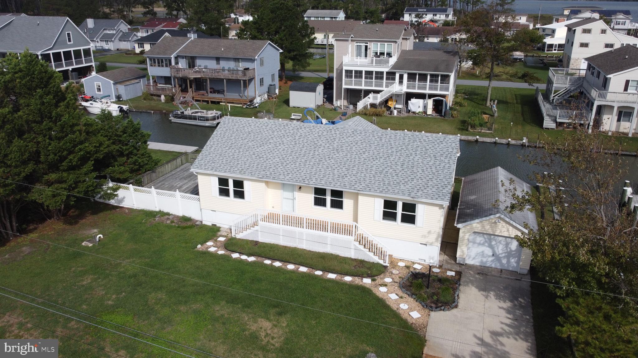**Boaters Dream House***SEWER IS BEING HOOKED UP ALLOWING MASSIVE EXPANSION OF THE HOME***Canal-front fully renovated raised rancher on Bookhammer Landing Rd. that offers panoramic views of Rehoboth Bay, Horse Marsh, and Horse Island! Perched amid enclave of magnificent, marina-inspired homes is this 3 bedroom, 2 bath home. Multi-tiered decks, myriad of glass sliders, sunroom, granite kitchen with new appliances, new roof, new HVAC, new paint, new carpeting, single garage, 100 feet of decking/dock, and more blend to create this unforgettable coastal home that is beachy, private, and serene. Ample space and ideal features for water living! Enjoy water activities with easy deck access for power boats, canoes, kayaks, paddle boards and jet skis. Welcome the opportunity to sip morning coffee off sunroom deck with views of surrounding shimmering water, bask in the sun and enjoy the canal life, unwind and read. Sunroom is striking and the perfect window-lined room to enjoy life. Home is located in the community of Joy Beach, which does not have restrictions on short term rentals, and is 7 mins. to Rt. 1 and merely 15 mins. to Rehoboth Beach/boardwalk/outlets. Beautiful home, bountiful space, bonus amenities, and breathtaking water views in this canal front charmer on Bookhammer Landing Rd.!  SPECIAL NOTE: Central sewer is now in place, which allows you to greatly expand the existing home or raze it and build a spectacular mansion in it's place.  Don't miss out on this gem!!