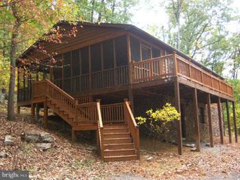 .Secluded Cedar Rancher, private mountain side lot offers privacy, seasonal views and interesting rock formations, 9.74 acres with river access, 3 bedroom, 2 br septic, 2 bath, Cathedral ceiling, lots of large windows for watching the wildlife. Nice Cabinetry with Island Kitchen, Central air and heat, wood laminate floors, Great room and Family/ Rec. room. Large screen porch and deck, A Must See!