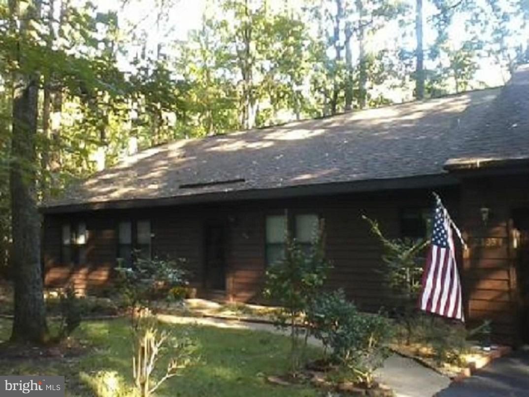 This BEAUTIFUL 3 bdrm/2 bath home WITH A DEN is in the desirable Wildewood community, located on a cul-de-sac, nestled in the trees with large picture windows, open floor plan, spacious kitchen, office/den, and 2 car garage on almost 1/2 an acre. LOTS of extra storage space, new carpet, gas fireplace, hot water circulator, over-sized deck. Owner providing 1 yr. Home Warranty. MUST SEE!