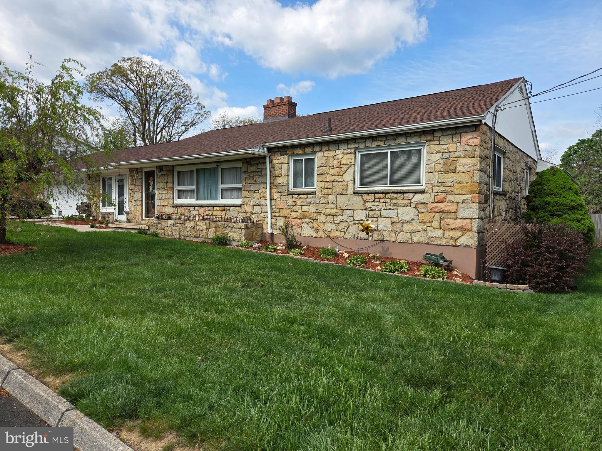 This beautifully maintained stone rancher combines timeless charm with spacious living and exceptional outdoor amenities. From the moment you arrive, the home’s attractive curb appeal and mature landscaping create a warm and inviting first impression. The main level offers a thoughtfully designed floor plan featuring a bright and comfortable living room, dining room perfect for gatherings, and a well-equipped kitchen with ample cabinetry and workspace. The cozy family room is highlighted by a wood stove, creating the perfect setting for relaxing evenings at home. Three generously sized bedrooms and two full baths provide comfortable accommodations and convenient onefloor living. The fully finished lower level greatly expands the home’s living and entertaining space. Enjoy a large family room complete with a wet bar, an additional recreation room ideal for game nights, hobbies, a home gym or could be used as a 4th bedroom, a full bath, and a dedicated laundry room with extra storage space. Step outside to your own private backyard retreat. The fenced rear yard features a sparkling inground pool, pool house, spacious rear deck, and patio area—perfect for summer entertaining, outdoor dining, and relaxing weekends. The beautifully landscaped grounds provide privacy and a peaceful setting for enjoying the outdoors. Additional features include a 2-car attached garage, a 1-car carport, and plenty of parking and storage. This exceptional property offers the perfect blend of indoor comfort and outdoor enjoyment.