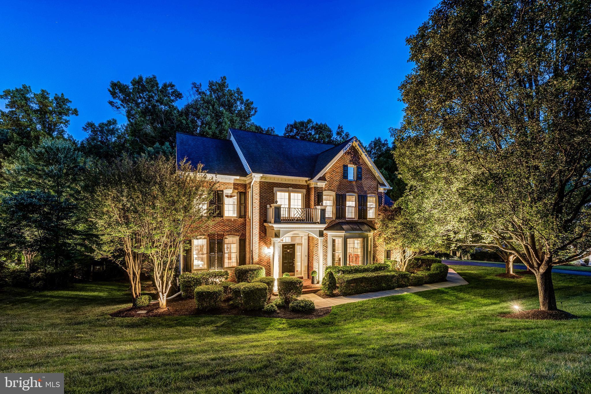 Welcome to 11885 Shaker Meadows Court, an exceptional Carr Homes estate nestled on a beautifully landscaped .84-acre lot backing to a private tree line in the exclusive Shaker Grove enclave of just 13 homes. This stunning 5-bedroom, 4.5-bath home offers over 6,400 square feet of beautifully finished living space across three levels. The main level impresses with hardwood floors, detailed moldings, and a seamlessly integrated kitchen and family room, highlighted by an elegant coffered ceiling and a gas fireplace. The updated kitchen shines with granite countertops, under-cabinet lighting, a stylish backsplash, and a dedicated desk workspace. Step outside to the expansive deck with outdoor speakers — perfect for entertaining while overlooking your serene, tree-lined backyard. Upstairs, the luxurious primary suite is a true retreat, featuring two custom walk-in closets, a built-in dresser, a sun-filled sitting room, and a spa-inspired bath with dual vanities, a jetted soaking tub, and a private water closet. The incredible walkout lower level offers a recreation room, gaming area, wet bar, expansive exercise room, and a fifth bedroom with a full bath. Thoughtfully updated and meticulously maintained throughout, this home is truly move-in ready. Perfectly situated in the heart of Herndon/Reston, you're just minutes from Reston Town Center, Silver Line Metro stations, major commuter routes, and Washington Dulles International Airport.