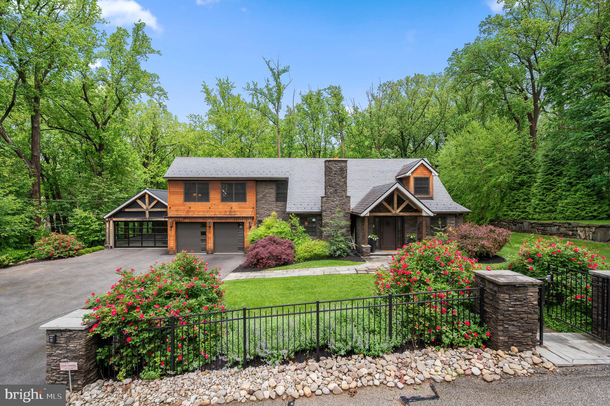 Welcome to 25 Bodine Road, an extraordinary residence that seamlessly blends timeless materials, handcrafted details, and modern luxury - all in the heart of the prestigious Tredyffrin-Easttown School District. Just a short walk to Daylesford Train Station, Conestoga High School, and T/E Middle School, this 5 Bedroom, 3 full and 2 half-Bathroom home offers truly elevated resort style living in one of the Main Line’s most desirable and convenient locations. Inside, the home is rich in architectural detail. Featuring reclaimed hardwood floors from a historic barn and redwood accents repurposed from a California estate. The open-concept layout is framed by exposed white oak ceiling beams in the main living area, adding architectural interest and sophistication. At its heart is a chef’s dream kitchen with top-tier appliances, an oversized island, and custom cabinetry, flowing seamlessly into living and dining spaces. A first-floor private office (or a 5th bedroom) provides a productive workspace, while a main-level bedroom suite offers flexibility for guests or multigenerational living. Upstairs, the Primary Suite features a luxurious Bathroom and a private outdoor deck overlooking the backyard retreat. Two additional bedrooms share a beautiful full Bath and the homework nook/second office, and Laundry on this level enhance the well-designed floorplan. The finished Lower Level is an entertainer’s dream, complete with a custom bar, glass-enclosed wine storage, commercial tap system, icemaker and a convenient half Bath. Outside, resort-style amenities await: a saltwater pool, separate saltwater spa, and a professionally installed sport court (imagine the pickleball parties), and are all surrounded by skillfully designed landscaping for added privacy. The covered slate patio, perfect for outdoor movies or game days, features stone wall accents and exposed ceiling beams, creating a warm, inviting ambiance year-round. A 4-car garage adds further utility for the car enthusiast and the whole house Generator provides peace of mind. Enjoy the proximity to the Amtrak train, Philadelphia Int’l Airport, major arteries and all the wonderful restaurants, upscale shopping and superb recreational outlets the greater Philadelphia area offers. Don’t miss this opportunity and schedule your private tour today!