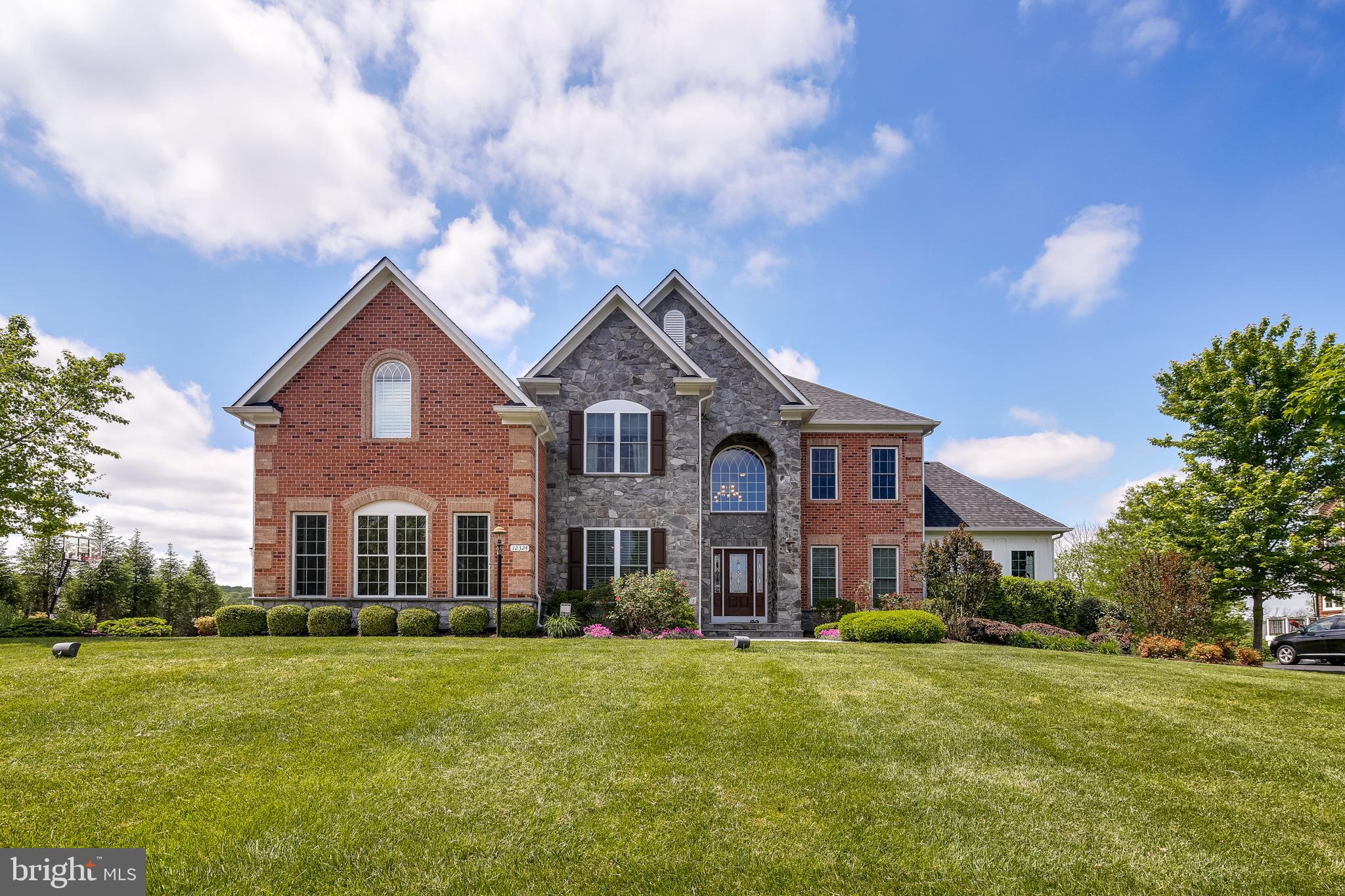 Fall in love with this absolutely spectacular former model home! This one-of-a-kind beauty begins with exquisite curb appeal, featuring a unique combination of stone and brick. Step inside and you are welcomed by the grand entry foyer with a gorgeous turned staircase. You are immediately greeted by elegant architectural upgrades which continue throughout and include upgraded moldings, decorative columns, tray ceilings, and so much more. Formal living and dining areas make for breezy entertaining, and the living room features access to the light-filled conservatory with coffered ceilings where you will love enjoying serene, tree-lined views. The impressive two-story family room serves as the centerpiece of this home, with its wall of windows flanking a fireplace. Continue into the fabulous gourmet chef's kitchen, outfitted with all the highest-end appliances and fixtures -- perfect for entertaining and preparing your favorite meals for guests. The kitchen opens to the separate breakfast room, where you will love enjoying morning coffee or casual dining. The main level is completed by a first floor library or in-law suite with a private full bath, as well as a half bath.  Upstairs, four bedrooms and three full baths await. The exceptional owner's suite is sure to impress with its elegant tray ceiling featuring contrasting paint, as well as its abundant size and dual walk-in closets. The attached owner's bath is a proper retreat, boasting of dual vanities, a soaking tub, and a separate shower.  The lower level is home to the fully finished basement, featuring a full bar and expansive rec room, perfect for entertaining any number of guests! The bedroom and full bath allow for easy overnight stays, and walk-out access brings you to the large, level rear yard with steps up to the fabulous back deck.  With all that this home has to offer, it is topped off by an incredible location within Howard County's Clarksville. Easy access to endless amenities and yet peaceful and private, this one must be seen to be believed.