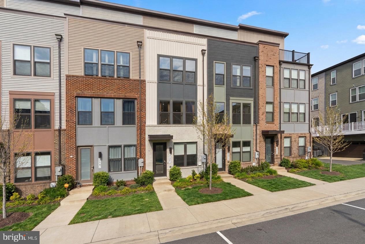 Welcome to 2505 Nicholson Street, an elegant townhouse in the highly desirable Riverfront community where contemporary design, generous living space, and a peaceful neighborhood setting come together seamlessly. Offering three bedrooms, three full baths, and two half baths, this thoughtfully designed residence provides stylish comfort just moments from Metro access, parks, and everyday conveniences. The entry level welcomes you with a flexible living space ideal for a home office, lounge, or additional sitting room, along with a convenient half bath and direct access to the garage. Upstairs, the main living level unfolds with an expansive open layout bathed in natural light, perfect for both entertaining and everyday living. The modern kitchen features crisp white cabinetry, stainless steel appliances, and a large center island with seating, complemented by designer finishes throughout. A dining area opens to a private balcony, while the spacious living room is framed by oversized windows overlooking the tranquil community. A stylish powder room completes the level.

The second floor hosts a serene primary suite with a spa-inspired bath, along with a second bedroom that works beautifully as a guest retreat. A full hall bath and conveniently located laundry area add everyday ease. The top level offers a private third bedroom with its own luxurious bath and access to a stunning rooftop deck, an inviting outdoor escape ideal for morning coffee or evening gatherings while enjoying expansive neighborhood views. Perfectly located just a short three-minute walk to the West Hyattsville Metro, the home also enjoys close proximity to grocery stores, scenic trails, cafés, and local dining. 2505 Nicholson Street delivers modern architecture, thoughtful functionality, and exceptional convenience in one of the area’s most vibrant communities.