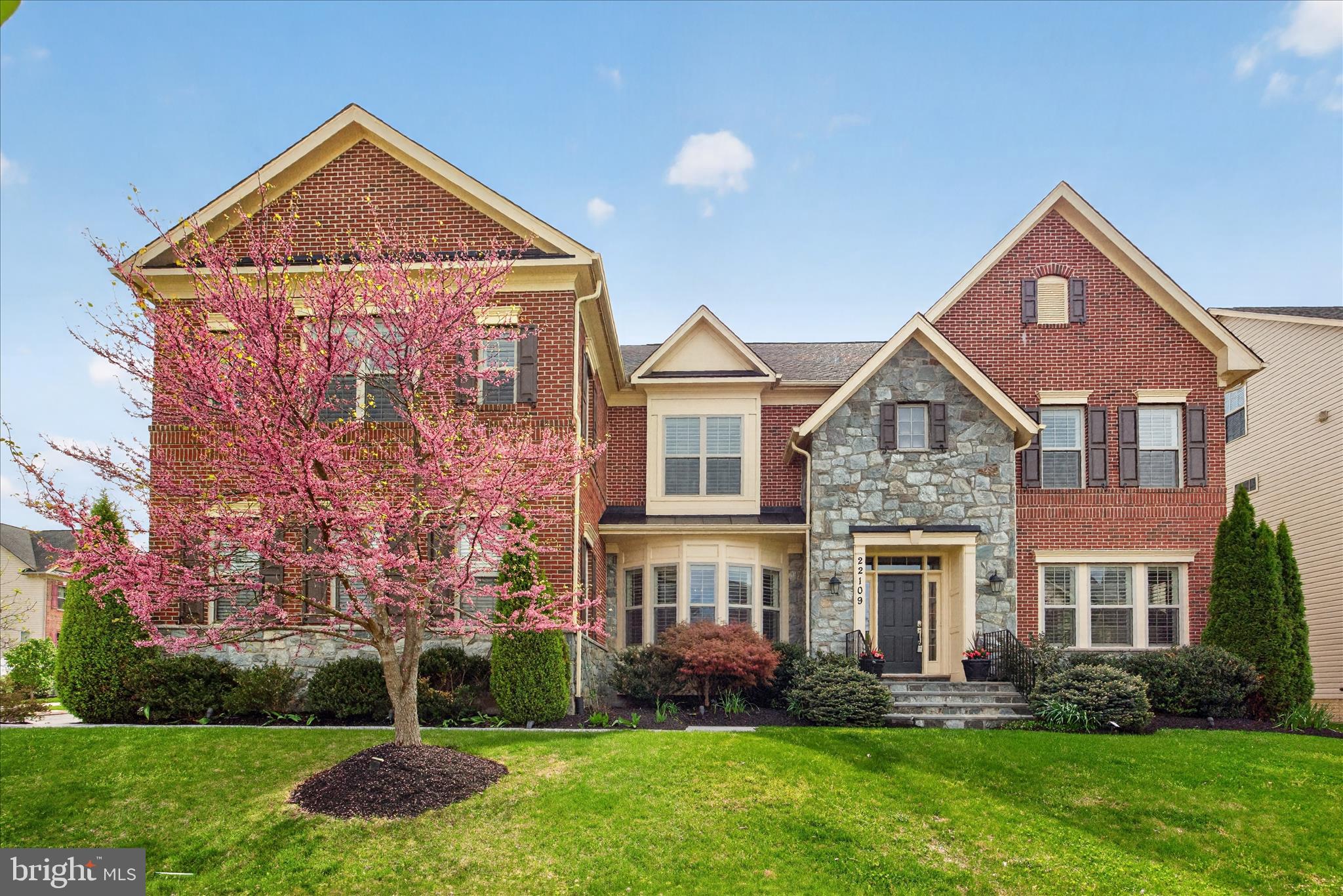 **Offer Deadline Sunday 4/19 @ 5PM**Welcome to this magnificent corner lot retreat, offering over 7,000 square feet of refined living space designed for those who demand the very best. From the moment you arrive, the side-load 3-car garage, elegant flagstone walkway leading from the driveway to the front door, and meticulously landscaped exterior set the tone for the extraordinary home that awaits within. Step inside to discover soaring high ceilings and an abundance of natural light pouring through windows at every turn, beautifully framed by custom plantation shutters throughout. Every room in this home is generously proportioned — from the sweeping living and dining rooms, to the spacious family room, sun-drenched morning room, and a private home office perfect for today's discerning buyer. Custom trim and crown molding add an elevated level of craftsmanship and elegance to every space. The family room, situated just off the kitchen, is anchored by a stunning stone fireplace — the perfect spot to gather on cooler evenings. The gourmet kitchen is a true showpiece, featuring a massive center island with seating for six or more, upgraded stainless steel appliances, a double wall oven, and a sleek vent hood over the cooktop — everything a culinary enthusiast could desire. Custom lighting throughout the home ensures an ambiance that feels both fresh and refined. The upper level is home to four spacious bedrooms, each with its own en-suite bathroom and a generously sized walk-in closet — several of which are outfitted with custom built-in drawers and storage systems, adding a boutique hotel quality to everyday living. The primary suite is in a class of its own — an expansive retreat of truly breathtaking proportions, highlighted by not one but two walk-in closets with custom built-ins, a dedicated linen closet, and a generous sitting room. The primary bathroom stuns with vaulted ceilings that lend an almost resort-like grandeur. Also conveniently located on the bedroom level is the laundry room, making everyday living as practical as it is luxurious. The fully finished basement is a world unto itself. A massive recreation room — currently used as a tv room but truly a blank canvas ready to be tailored to your lifestyle — is warmed by a second gorgeous stone fireplace, creating an inviting and flexible space for entertaining, relaxing, or whatever you envision. A dedicated gym, a fifth bedroom, a full bathroom, and a large storage area round out the lower level, offering versatility for every need. Walk-up stairs provide convenient direct access to the rear yard, seamlessly connecting indoor and outdoor living.
Outside, your fully fenced backyard oasis has been thoughtfully designed for both beauty and function. Custom landscaping and hardscaping create a stunning backdrop, while the sparkling pool takes center stage — flanked by a sun-soaked lounging area on one side, perfect for stretching out and soaking up the sun, and a dedicated al fresco dining area on the other, ideal for evening meals and entertaining under the open sky. Beyond your private retreat, the community offers an exceptional lifestyle with two additional pools, multiple playgrounds, scenic nature trails, and convenient access to shopping, dining, and major commuter routes. This is more than a home — it's a statement. A rare opportunity to own one of the finest residences on the market today.
