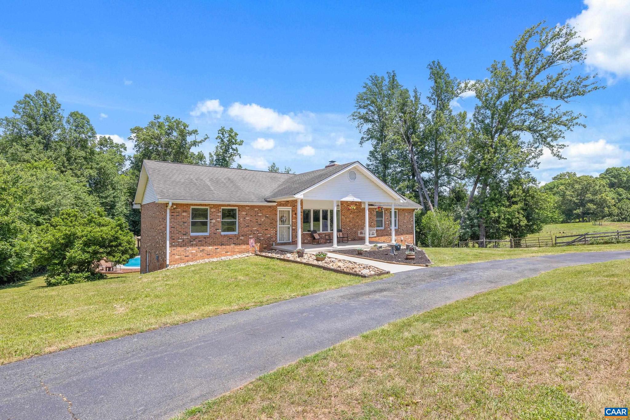 Spacious brick ranch with exceptional indoor and outdoor living! This spacious home features an open floor plan, lovely hardwood floors, and a cozy gas fireplace (converted in 2023). The fully finished walkout basement offers incredible flexibility with its own kitchenette, full bath, bedroom, living room, oversized laundry room (2025 smart washer and dryer), and a nicely equipped HOME GYM WITH SAUNA - all INCLUDED in the sale. Step outside to an entertainer's dream. A screened porch with an adjoining grilling deck overlooks the stunning in-ground pool with a newer liner (2025). An expansive infinity-style deck leads to the pool area, while the fire pit with built-in seating creates the perfect spot for evenings under the stars - set up an outdoor projector for unforgettable summer movie nights! The oversized 730+ sq. ft. garage, complete with a new garage door (2026), provides ample space for parking, storage, or a workshop. Additional upgrades include a new water heater (2026), updated ceiling fans (2025), rebuilt infinity decking (2025), rain shower heads in every bathroom, and smart lighting. This home offers the potential for an income-producing basement apt - some homes look great in pics, this one is even better in person!,Fireplace in Living Room