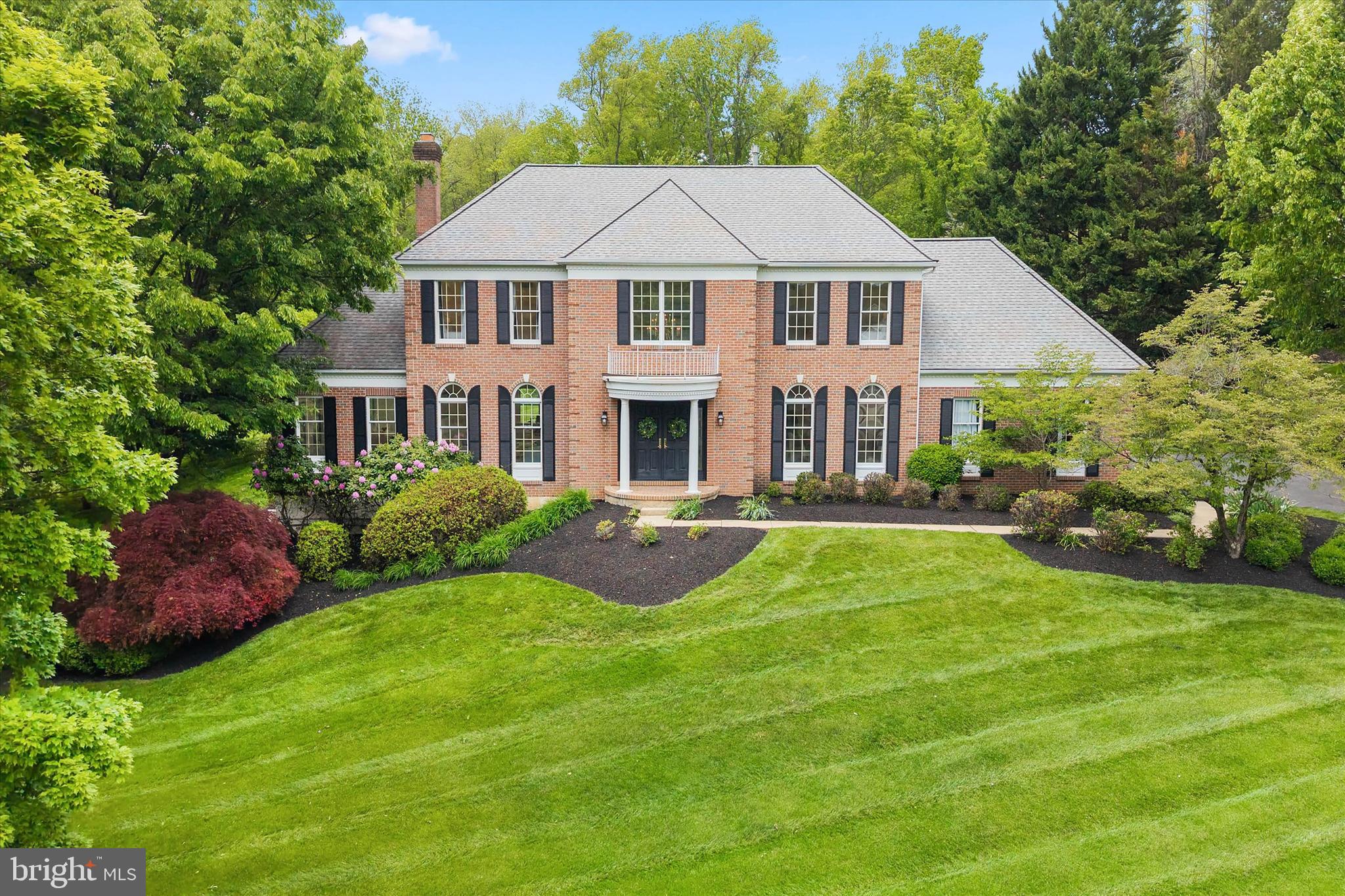 Welcome to 1605 Masters Way, an exceptional 4 Bedroom, 4 Full Bath, and 1 Half Bath luxury residence located in the prestigious community of The Reserve at Chadds Ford within the award-winning Unionville-Chadds Ford School District. Perfectly situated on a private 1-acre lot backing to the Brandywine Conservancy, this extensively updated home offers over 5,000 square feet of elegant living space designed for both refined entertaining and everyday luxury living.

From the moment you arrive, the stately brick exterior, timeless architecture, and picturesque setting create a striking first impression. Inside, the beautifully refreshed interior features newly installed white oak hardwood flooring, updated molding, fresh paint, sophisticated finishes, and designer lighting throughout the home. The grand entryway was thoughtfully redesigned to create a brighter, more open feel filled with natural light.

Designed for today’s lifestyle, the Owners opened the Family Room to the Kitchen creating seamless flow throughout the main living spaces. The gourmet Kitchen with eat-in area serves as the heart of the home and features premium Wolf appliances, double ovens, custom cabinetry, and an ideal layout for both everyday living and entertaining. The Kitchen opens directly to the spacious Family Room with wood-burning fireplace and formal Dining Room. A dramatic Conservatory with its own fireplace provides an additional light-filled living space ideal for entertaining, or relaxing.  A private first-floor Office offers the ideal work-from-home setup and has become one of today’s most sought-after luxury home features. Step outside to the expansive deck with screened canopy overlooking the flat, private backyard surrounded by natural beauty.

The elegant butterfly staircase leads to the luxurious Primary Suite featuring vaulted ceilings, dual walk-in closets, additional custom closet space, and a beautifully updated spa-inspired Bath. The Owners thoughtfully enhanced the upper level by adding an additional Full Bathroom to the second Bedroom, creating a more functional and private layout ideal for guests and everyday living. Three additional generously sized Bedrooms offer excellent closet space, while a newly added third-floor Full Bath with laundry hookups adds incredible flexibility and convenience for guests, extended family, or future additional living space. A second-floor Laundry area further enhances everyday functionality.

The finished walk-out Lower Level offers exceptional additional living space complete with luxury flooring, a newly added designer Full Bath, private Exercise Room/flex space, and large windows with sliding glass doors providing abundant natural light and direct access to the yard.

Extensive updates throughout the home include renovated Bathrooms, custom closet enhancements, upgraded lighting, new landscaping, interior and exterior lighting, and major flooring upgrades. Additional highlights include dual HVAC systems, whole-house generator, irrigation system, many newer windows, and exceptional storage.

Located in the heart of Chadds Ford, this home offers convenient access to Philadelphia, Wilmington, the Main Line, Route 1, Route 202, Longwood Gardens, renowned golf clubs, upscale dining, boutique shopping, scenic trails, and downtown West Chester. 1605 Masters Way offers the rare combination of luxury, privacy, convenience, and timeless Chester County beauty.
