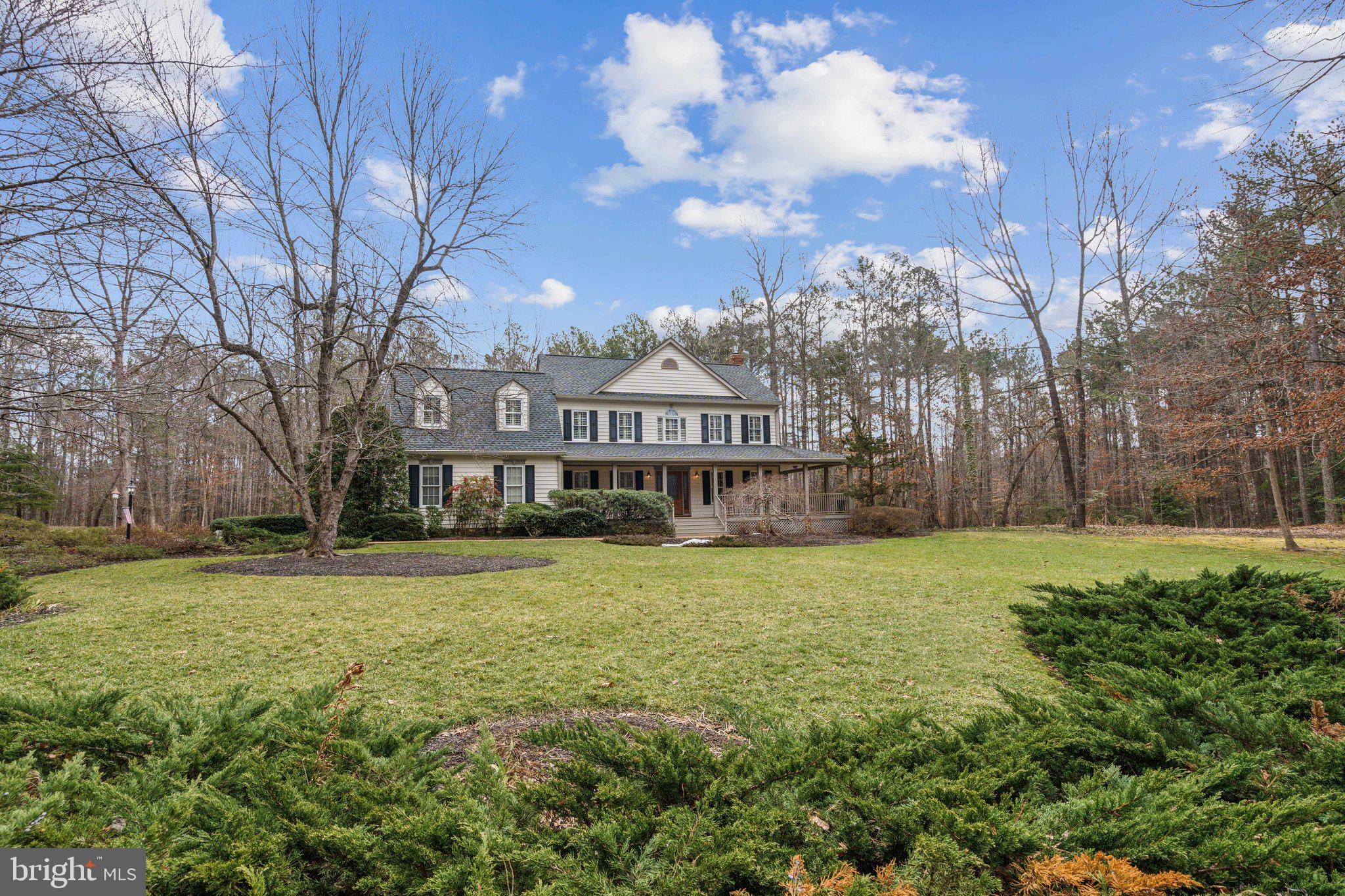 This home is spectacular! First-time sale of a meticulously cared for and upgraded home on 10 private acres in the elegant and walkable Pinehurst Neighborhood. The sellers have passions for quality, landscaping, and lifestyle. A gently curving drive provides views of the gorgeous lawns, curated landscaping, and sweeping front of this 4 bedrooms 3 bathroom turnkey home with its deep wrap-around porch. A professionally installed sport court has an adjustable basketball standard and markings for tennis or can be used for pickle-ball, rollerblade hockey and games. On the side of the home you'll pass the oversized 2 car garage to a stunning back yard paradise. Winding paths, decks, and fabulous gardens invite you to relax. During rain storms, the rock beds turn into brooks that flow under elegant bridges. Relax in the hot tub as you watch the butterflies and hummingbirds sipping nectar from the flowers. Enjoy the fire pit or a backyard barbecue. Inside the home you'll be delighted by the classic color pallet and enduring quality of every fixture and surface. From the foyer, enter into the living room through french doors or into a formal dining room. The family room features a top quality wood-burning stove and deep hearth. The sunroom invites you to enjoy the views of the private outdoors. The gourmet kitchen leads to a breakfast room with a vaulted ceiling and pristine skylights. You'll be delighted by the massive butlers pantry with new custom shelves organizers from the Container Store. The laundry room, extra workshop, and garage entry provide additional options for customizing your space. Upstairs, enjoy 4 bedrooms and 2 bathrooms. The large primary suite features a gorgeous remodeled ensuite bathroom. All systems in this home are in fabulous condition. Conditioned crawl space, lifetime warranty on the roof and gutters, radiant barrier in attic, whole house generator, plantation shutters, 2 replaced HVAC.