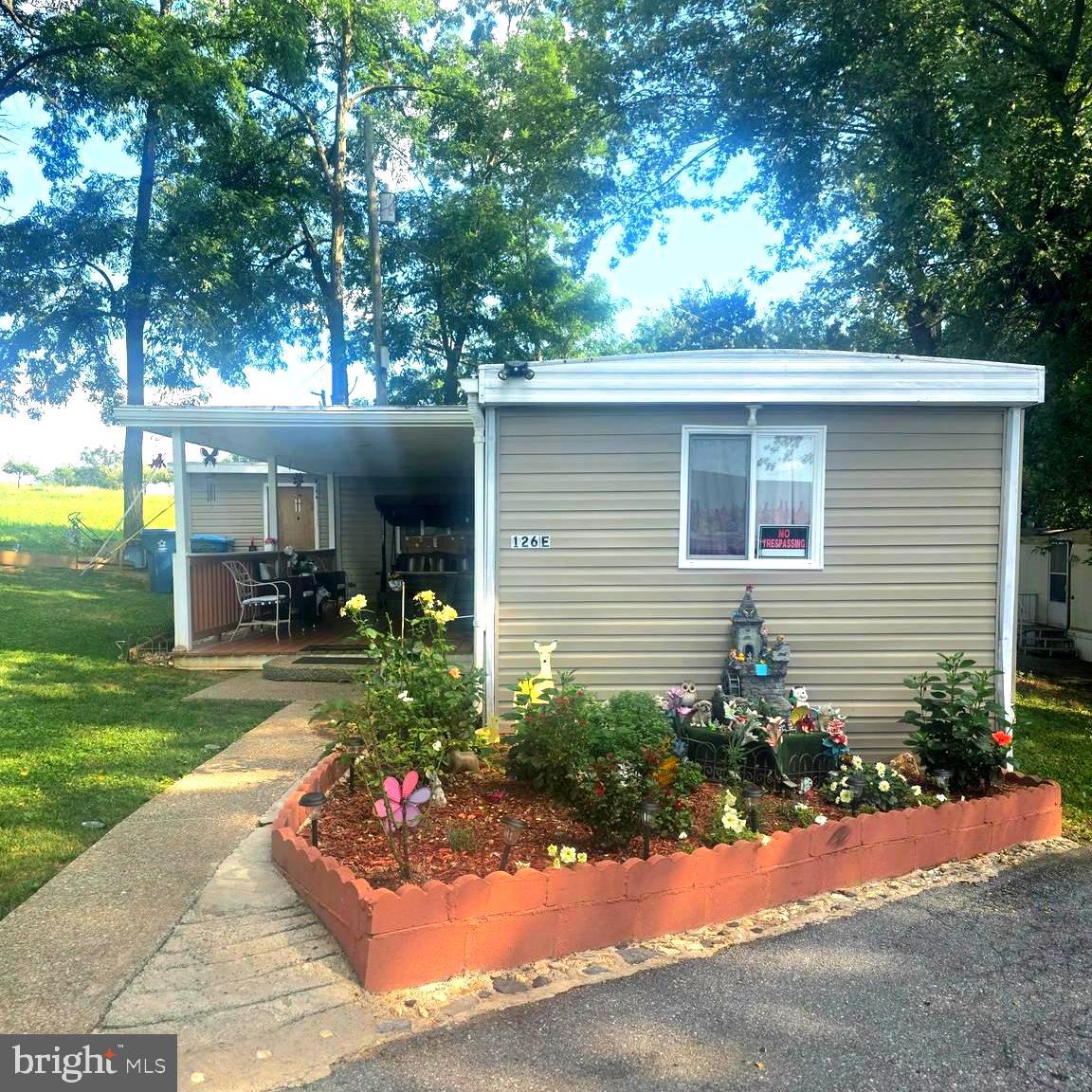 Corner lot charm meets everyday convenience at 126 E Lane in Harrisburg. This move-in-ready 2-bedroom, 1-bath home with bonus room delivers the kind of comfortable, low-fuss living that's hard to find. Hardwood floors run throughout, the kitchen offers generous cabinet space, and a solid covered front porch sets the tone for slow mornings and easy evenings. The private corner lot gives you breathing room — plus ample parking and a yard that's actually usable. Lot rent covers water and trash, so you can spend less time managing and more time living. Minutes from major highways, shopping, dining, and Hersheypark. Simple. Central. Ready for you.