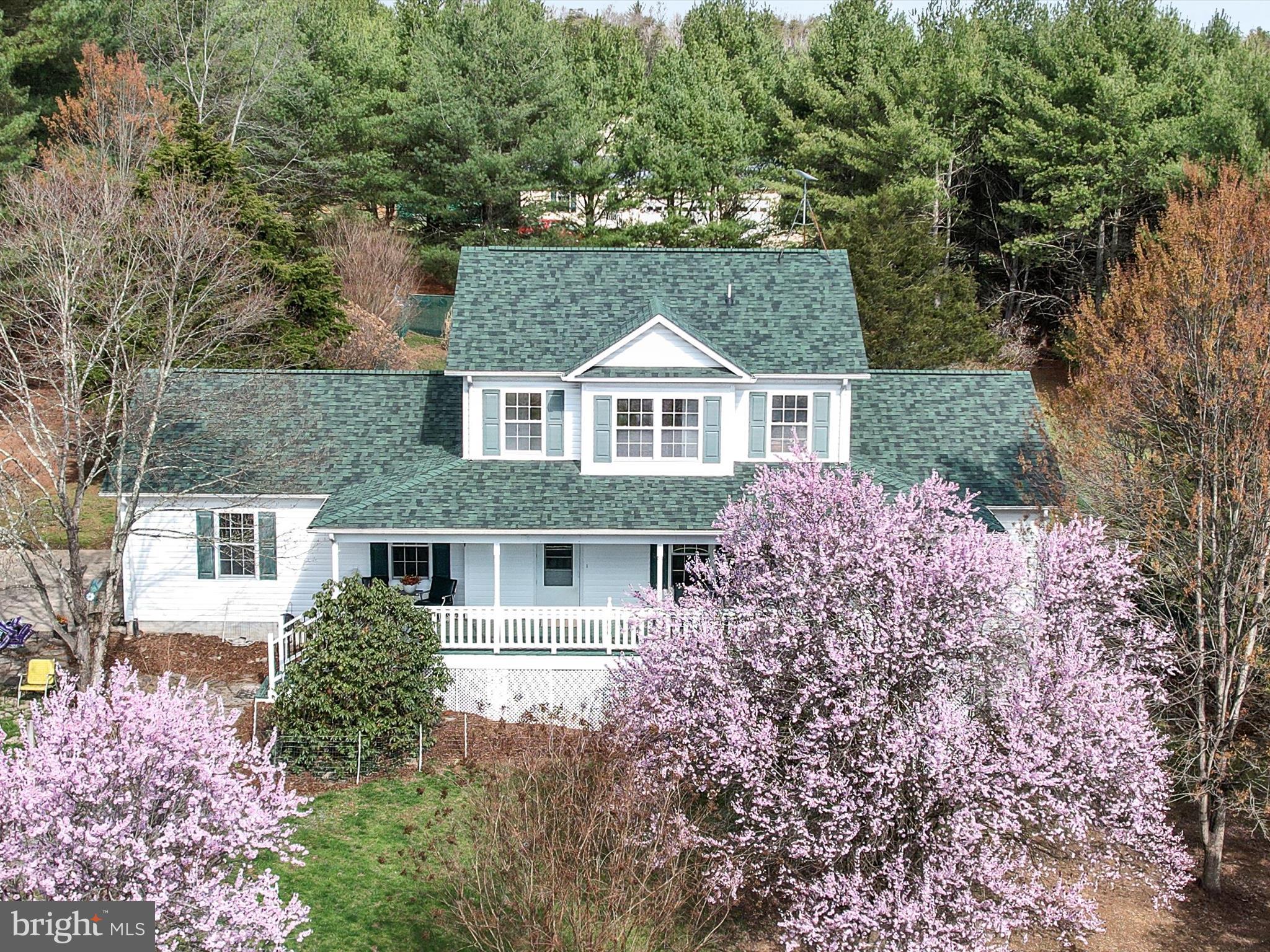 Back on the market at no fault of the seller!!
Welcome to 133 Pond View Lane! This charming traditional-style home sits on a picturesque 5.35-acres, offering a peaceful retreat with stunning seasonal blooms. Just 1.25 miles from Route 522 and 2.4 miles to Gainesboro Elementary and Frederick County Middle School. This well-maintained, one-owner home is move-in ready with a new roof (2023) and septic pumped (end of 2024). Step inside to find 3 bedrooms and 3.5 baths, designed for comfortable living. The main-level primary suite features a private en-suite bath and walk-in closet, providing ease and convenience. Hardwood floors throughout add warmth to the spacious living room and cozy kitchen with an inviting dining area. Downstairs, the fully finished basement with a full bath offers endless possibilities; use it as a recreation room, guest suite, or home office. Outside, enjoy breathtaking views from the expansive, freshly painted covered front and back porches. The low-maintenance landscape boasts cherry, plum, redbud, and wisteria trees, along with blueberry bushes and perennials that bloom from spring through fall. A fenced backyard includes two raised garden beds, perfect for growing your vegetables. The two-car garage offers extra storage and convenience in addition to an 18 x 21 shed for additional storage. A one-year home warranty provides peace of mind. Located just minutes from shopping, schools, restaurants, and the hospital, this home offers the best of rural tranquility with urban accessibility. Don’t miss your chance to see this beautiful property in full bloom. Schedule a showing today! All sizes are approximate.
Note—wall-unit propane heaters are an additional heat source. The heat is forced air propane on the main level and a heat pump on the second level.