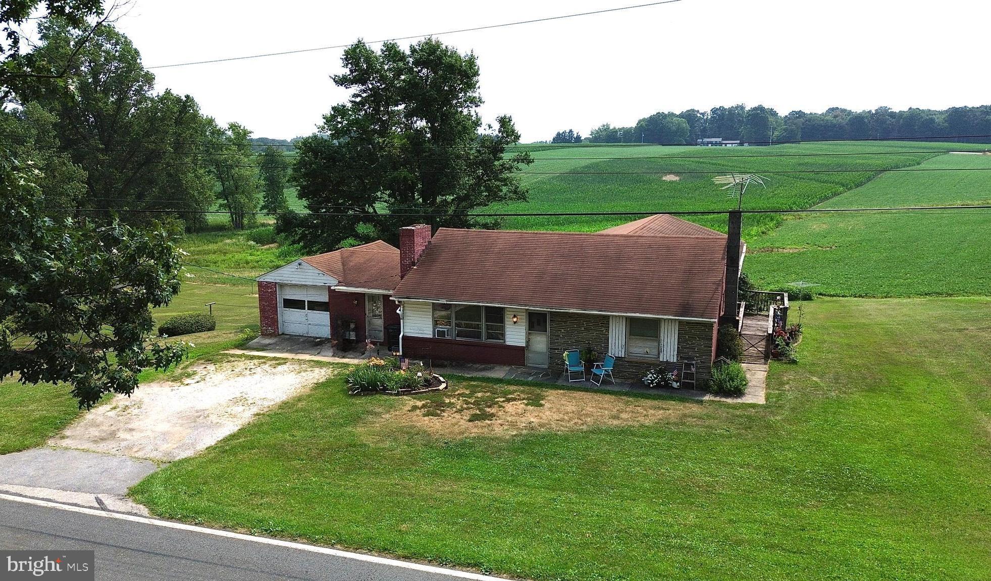 Welcome Home to this unique Rancher here in Hampstead, MD. The home has an absolute ton of potential as a 2 unit, or a single family dwelling. The original home has a 1 car attached garage with a separate garage space down below, a charming breezeway/mudroom, a large kitchen with wooden cabinetry/plenty of storage space/and lots of natural light, family room off of the kitchen with woodburning fireplace and hardwoods under carpet, 2 spacious bedrooms with hardwood flooring, full bathroom, main level laundry room, and access to the unfinished basement and lower level garage space.  The 2nd unit addition is separately metered, has it's own dedicated outside entrance with ramp on the right side of the home, the family room is very large, has a full kitchen with hardwood cabinetry and dining area, 1 bedroom and full bathroom. There is also a huge 2 car garage beneath the addition with wrap around vehicle access coming from the front driveway. Bring your vision for this property, and book your showing today!
**DO NOT WALK ON REAR DECK - IT IS UNSAFE**