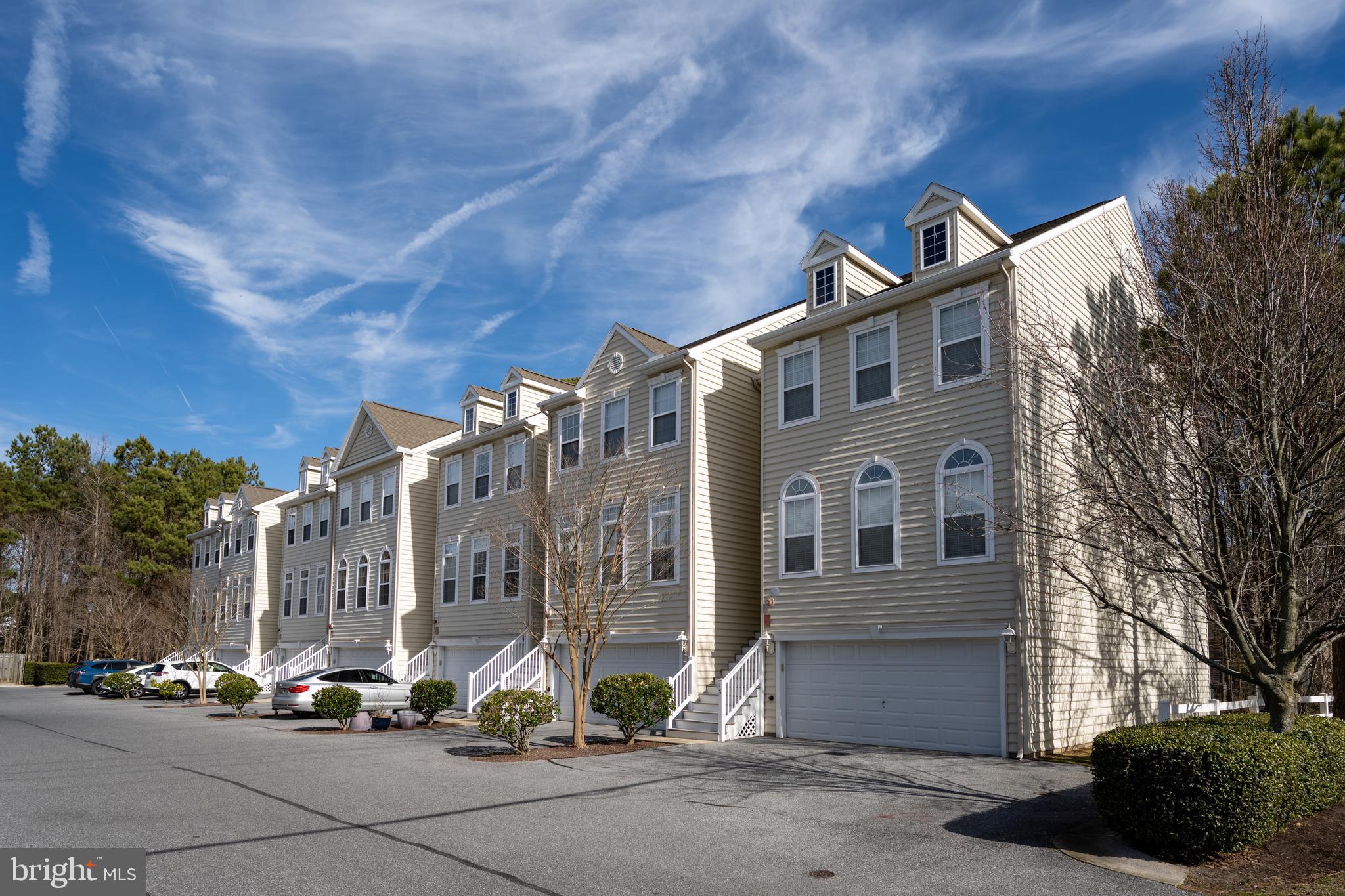 Nestled in the highly desirable West Ocean City area, just 2 miles from the vibrant shores of Ocean City, West Harbor Village is a premier community offering the perfect blend of tranquility and convenience.  This spacious three-level townhouse is designed to provide comfort, flexibility, and an exceptional coastal lifestyle.  First Floor:  The entry level features a large studio/office space, ideal for remote work or creative pursuits. This floor also includes a bedroom and a full bathroom, making it an excellent space for guests or multigenerational living. The attached two-car garage ensures ample parking and storage, while the outdoor patio offers a private retreat, backing up to peaceful woods.  Second Floor:  The heart of the home is on the second level, where an inviting sunken living room with a gas fireplace awaits. A bright foyer, half bathroom, dining area, and cozy sitting space complete the main living areas. Adjacent to the sitting area is the well-appointed kitchen featuring an island breakfast bar, perfect for casual meals and entertaining. Step outside to the sundeck, an ideal spot for enjoying morning coffee, hosting gatherings, or soaking in the coastal ambiance.  Third Floor:  Upstairs, you’ll find two luxurious master suites. Each boasts a spacious walk-in closet and a spa-like en-suite bathroom equipped with double sinks, a Jacuzzi tub, and a walk-in shower. These private retreats are designed to provide ultimate relaxation and comfort. 
 Location Highlights:  This home is a haven for boating enthusiasts, offering quick access to the Commercial Fishing Harbor, Sunset Marina, Harborside, Micky Fins, and The Ocean City Fishing Center Marina. Whether you're setting sail for a day on the water or enjoying fresh seafood and stunning sunsets, you'll appreciate the convenience of this location.  Situated in quiet and scenic West Ocean City, this community offers a serene residential setting while being moments away from the dining, entertainment, and attractions of Ocean City. Whether you’re looking for a full-time residence or a vacation home, this townhouse combines coastal charm with modern convenience, ensuring you can enjoy the best of both worlds.  Schedule your tour today and experience the unparalleled lifestyle that West Harbor Village has to offer!