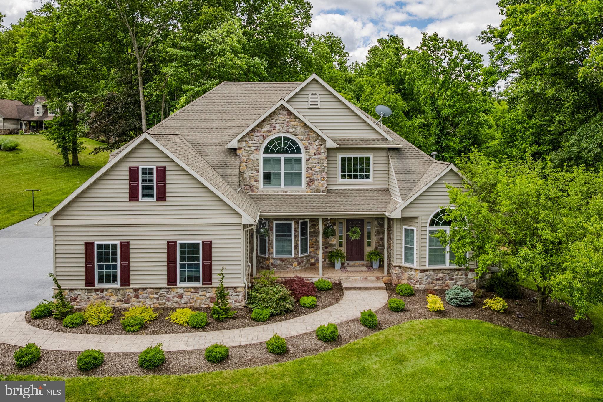 THIS PROPERTY IS GOING TO AUCTION ON WEDNESDAY JULY 22, 2026 @ 6:30 PM. THE LIST PRICE ONLY REFLECTS THE SUGGESTED STARTING BID. Super rare opportunity to buy your own personal show place on 2.76 acres! Built in 2007 by Blue Lake Builders, this home has approx. 2,700 sq. ft. plus an additional 1,784 sq. ft. in the finished basement. Main level offers a front door foyer with sitting area; kitchen/dining area; living room with 18' ceilings and stone fireplace; primary bedroom with private bath; half bathroom; laundry/mud room. Second level features 4 additional bedrooms and a full bathroom. Extensive finished basement has poured concrete walls; great room with stone fireplace; second kitchen with eat-at counter; full bathroom; office closet behind double doors; storage room. On-site well with UV light, on-site septic, 200-amp service, Rheem oil furnace, Honeywell central A/C, good air handler with humidifier. Attached 21' x 26' 2-car garage plus a 14' x 32' garage shed with electric service and rear addition for covered firewood. Oversized backyard has extensive raised garden area, 16' x 12' chicken shed with cages and covered runs, 40' x 40' wood-chipped play area with swing set, beautiful stamped concrete front walkway, good macadam driveway. You really need to set your foot on this property to understand how nice and well-maintained it is. Make plans to do that today!