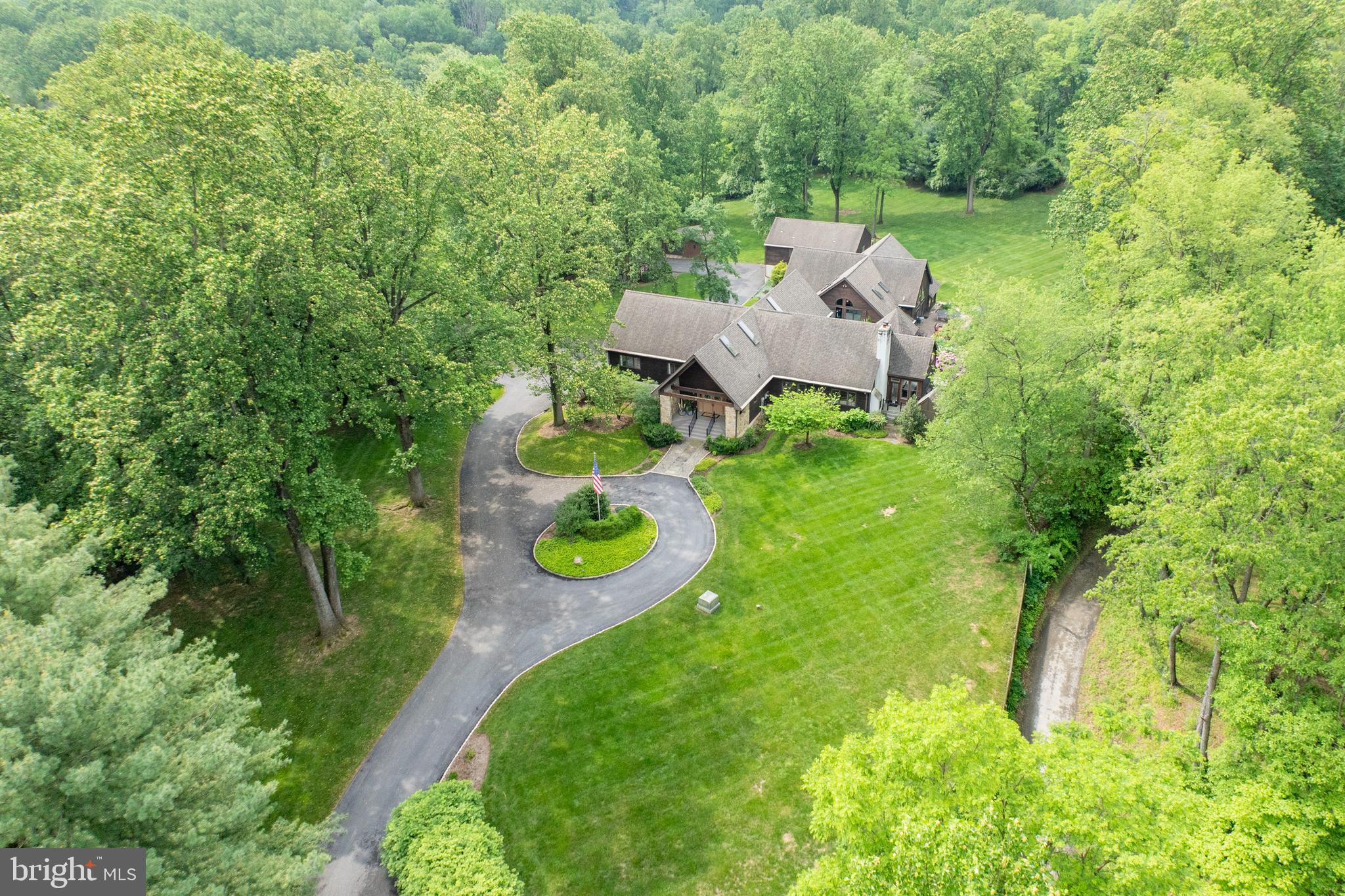 Ever dreamed of living at a private resort where you make the rules? Good news: it's for sale.

Set on 3 beautifully landscaped acres with a front-row seat to Phoenixville Country Club’s rolling greens, this one-of-a-kind estate brings vacation vibes home every single day. At the heart of it all is the jaw-dropping two-story Wellness Pavilion featuring a heated saltwater indoor pool (complete with diving block and stone slide), hot tub, cold plunge, steam room, sauna, wet bar, and two full baths. Sunlight pours in from skylights and massive windows, while glass doors open to a sun-drenched patio built for pool parties and peaceful lounging alike.

The rest of the property carries the same wow factor. A massive brand new composite upper deck with a waterfall and gazebo overlooks a yard that’s private, peaceful, and perfectly in sync with the golf course fairway just beyond. A second full residence (yes, an actual second house) is perfect for guests, in-laws, or long-term visitors, with 2 bedrooms, 2 full baths, a dining room, and a bright family room with sliding doors that open to its own private deck. It also includes a full kitchen, laundry, and a 4–5 car garage.

The main home is a masterclass in post-and-beam architecture, flooded with natural light and filled with flexible, elegant spaces. Soaring ceilings highlight the central dining room with its trio of chandeliers, while the gourmet kitchen includes both a peninsula and an island, a Viking gas range, two Viking dishwashers, and GE Profile fridge. It connects to a relaxed family room where the stone fireplace sets the tone.

Just off the kitchen, the sunlit breakfast room includes a coffee station with mini fridge, sink, and ice maker, making it your new favorite spot to start the day.

The primary suite? It’s got private deck access, spa bath with soaking tub and double vanity, and a walk-in closet that finally gives your wardrobe the space it deserves.

Downstairs, the walk-out lower level feels more like a private club, with a full wet bar featuring white cabinets, quartz countertops, a dishwasher, two ice makers, two wine refrigerators, a sink, and tiled backsplash—plus a wine cellar, game room, TV room, two offices, full bath, mudroom, and access to an oversized two-car garage.

Additional highlights include brand new decks, a newer roof, a new driveway, a water filtration system, and even a charming chicken coop out back. All of this just minutes from Valley Forge National Park.

An estate that redefines what home can be.